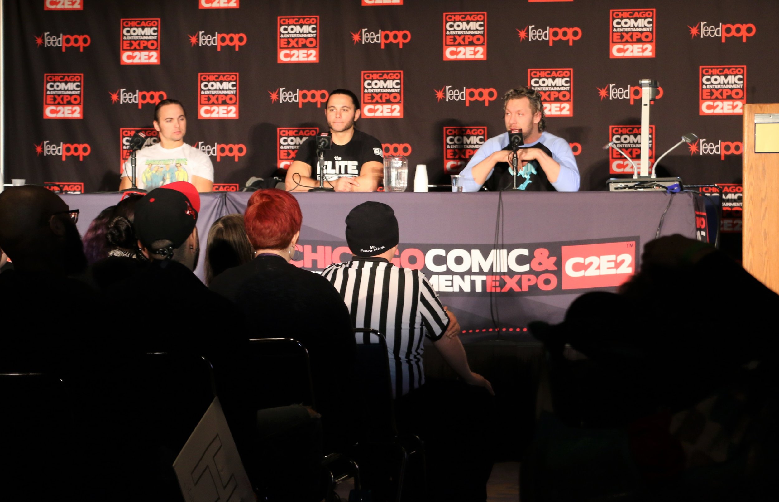  A packed conference room watches the Young Bucks and Kenny Omega during the All Elite Wrestling panel. 