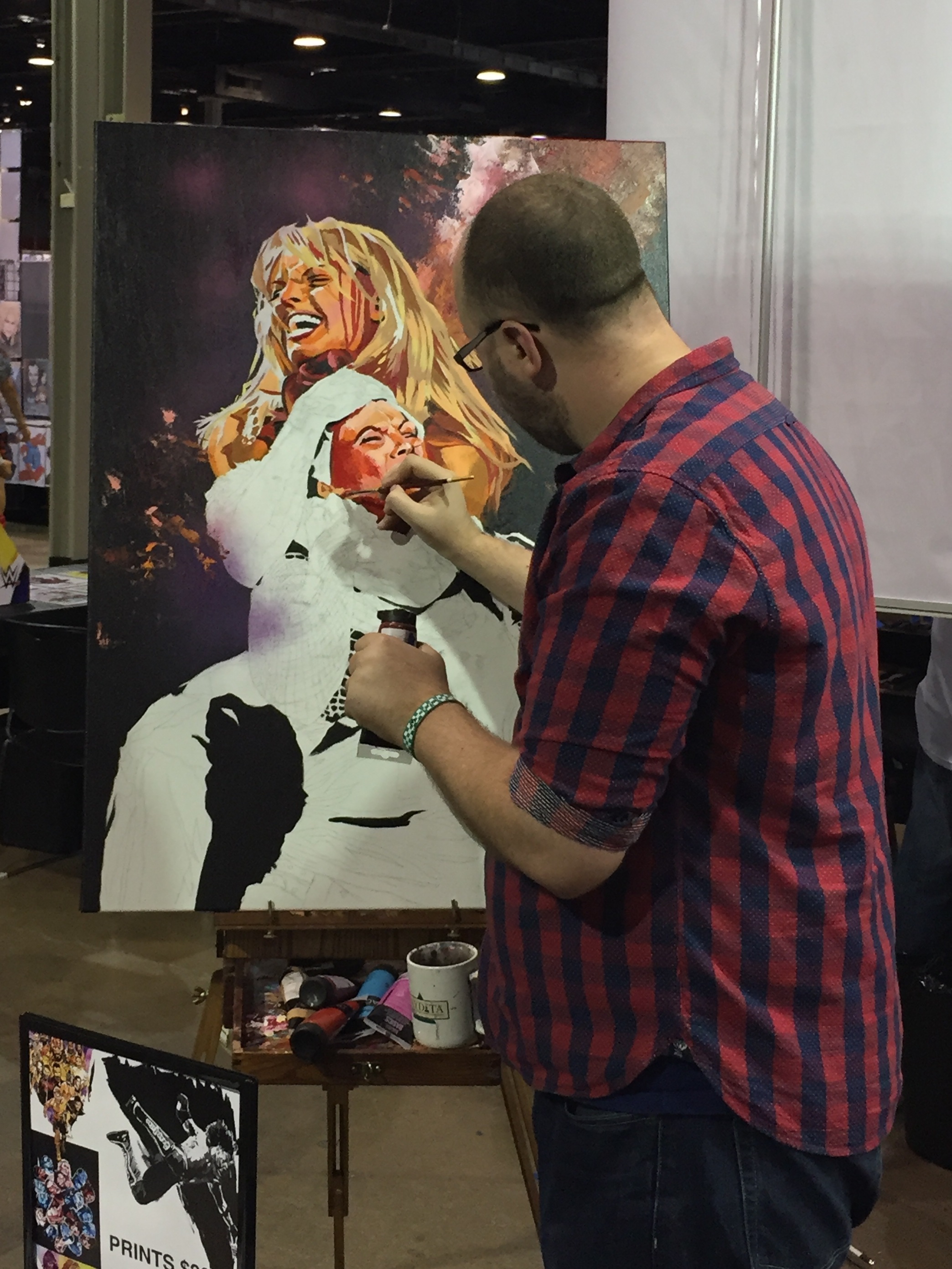 Rob Schamberger works on a piece depicting WWE Hall of Famers Trish Stratus and Lita during Wizard World Chicago in August 2017. (Photo by Mike Pankow)