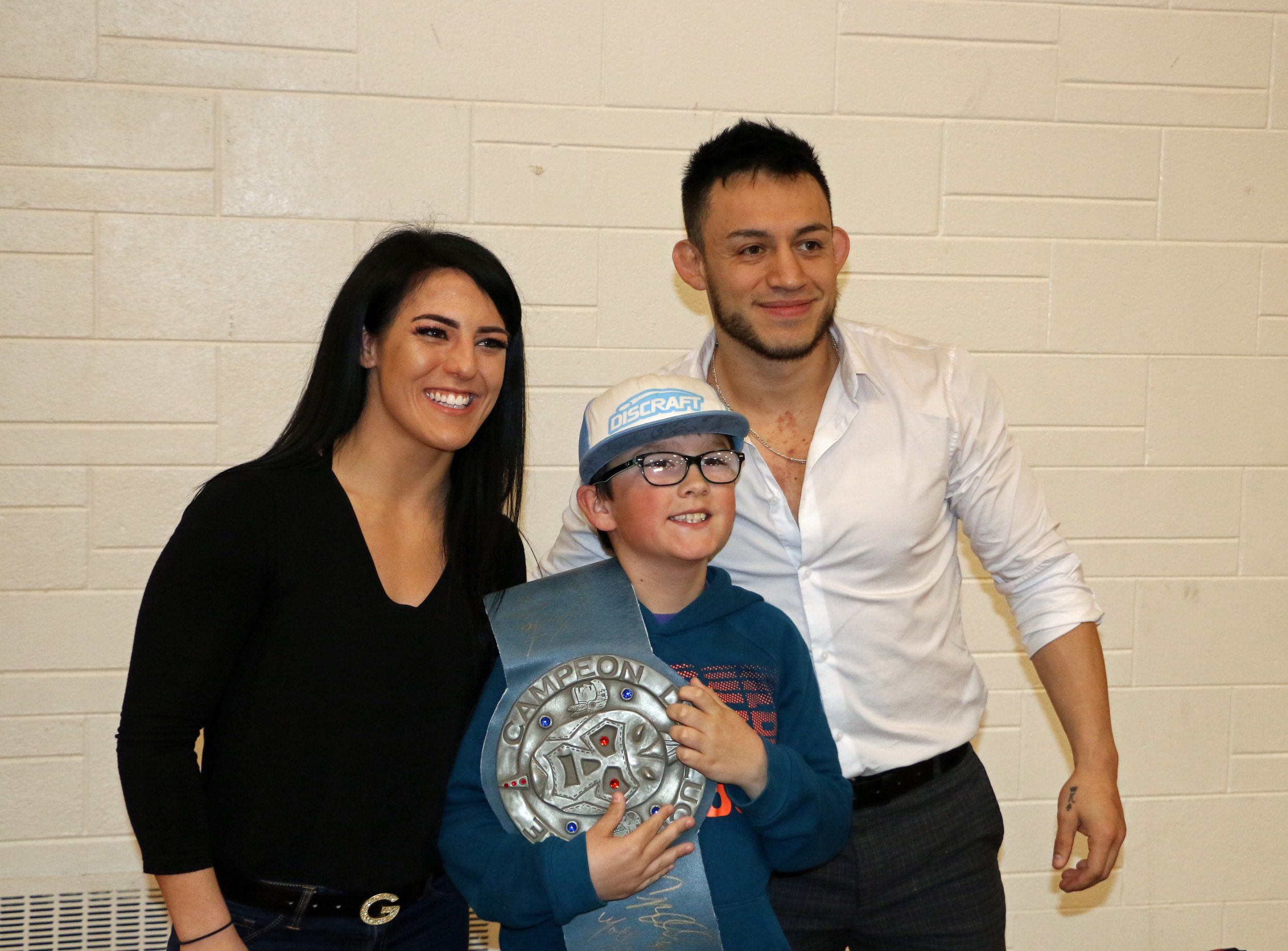 Tessa Blanchard, left, and Daga, right, pose with a young fan at the Warrior Wrestling 5 fan fest on May 12. (Photo by Mike Pankow)