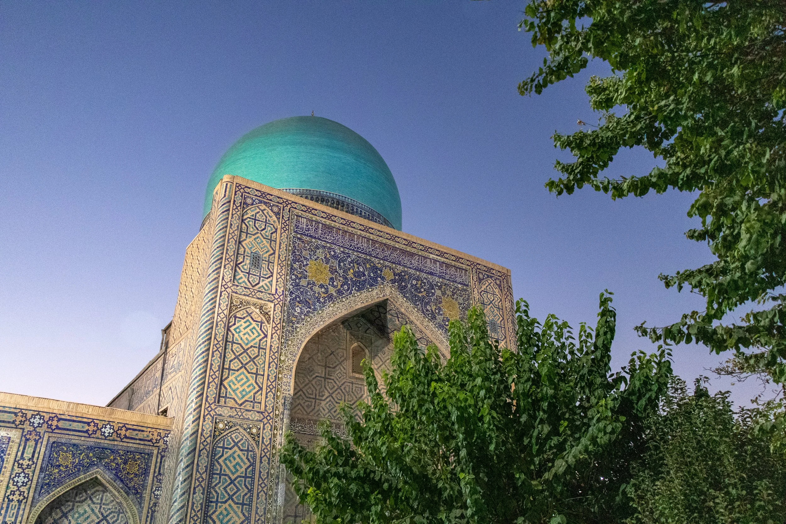 View of the blue dome of Tilya Kori Madrasa from its interior courtyard, Registan, Samarkand, Uzbekistan.