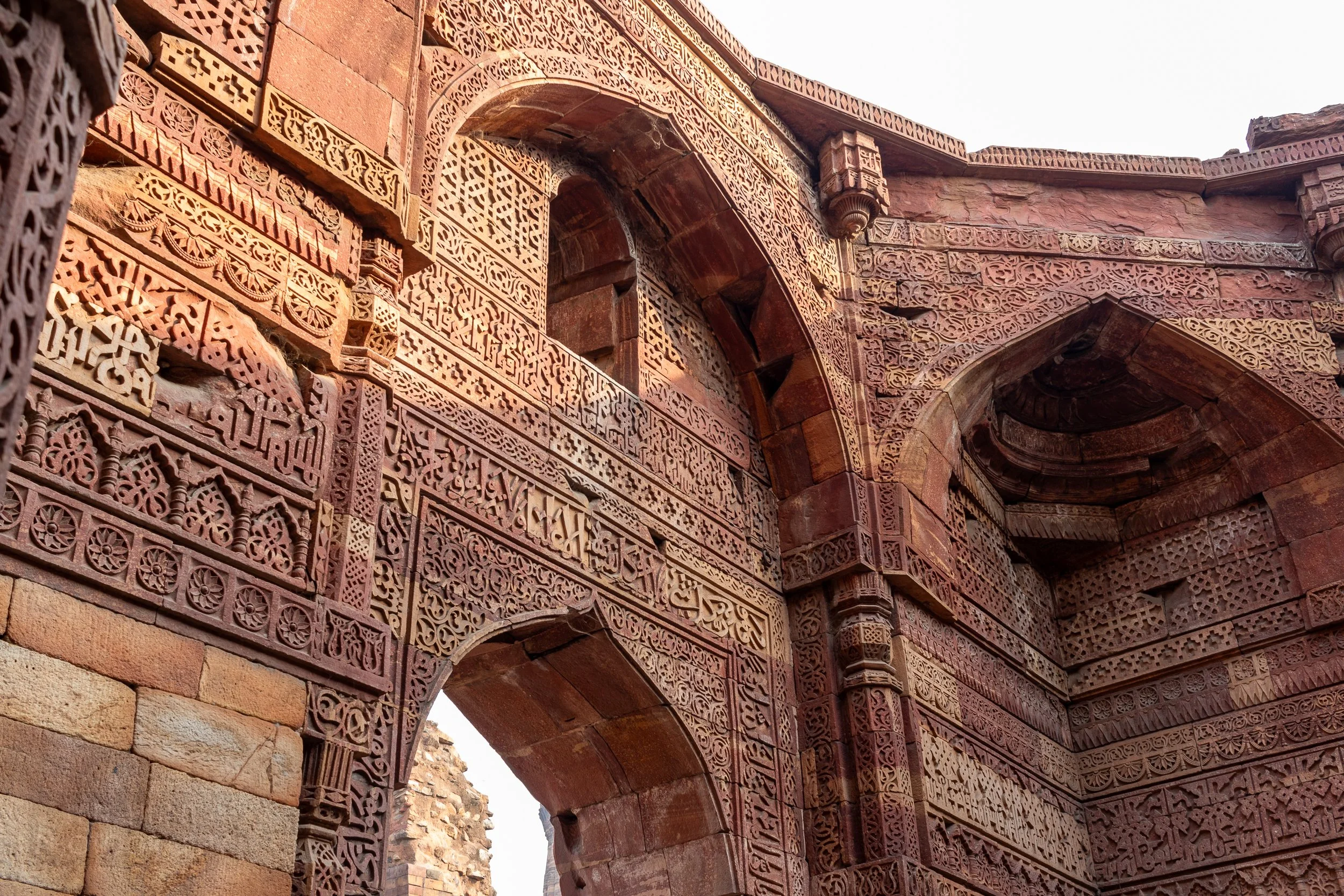 A carved stone facade within the Qutub Minar complex, Delhi, India.