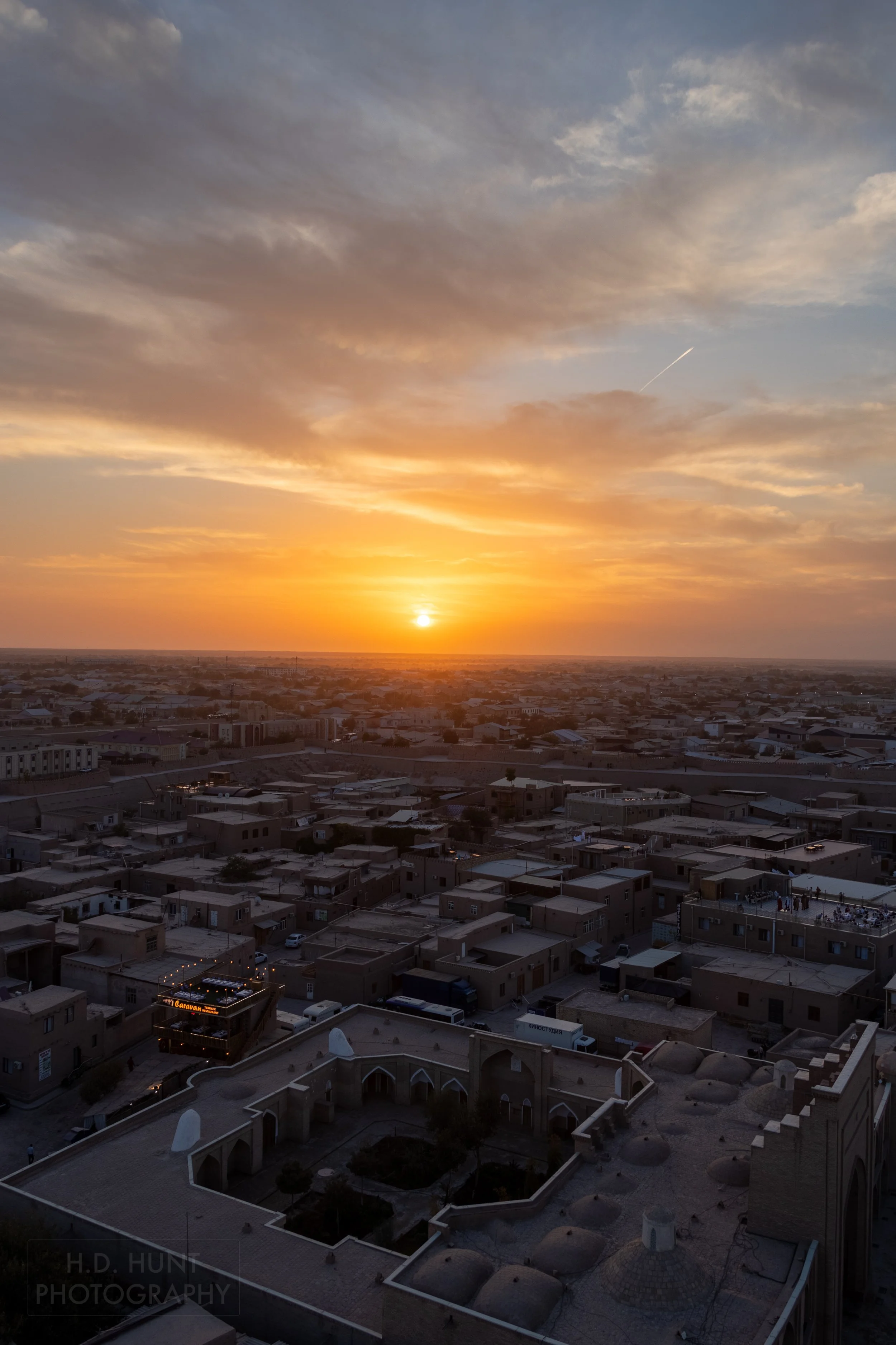 The sunset is seen from the top of the Islam Khoja Minaret, Khiva, Uzbekistan.