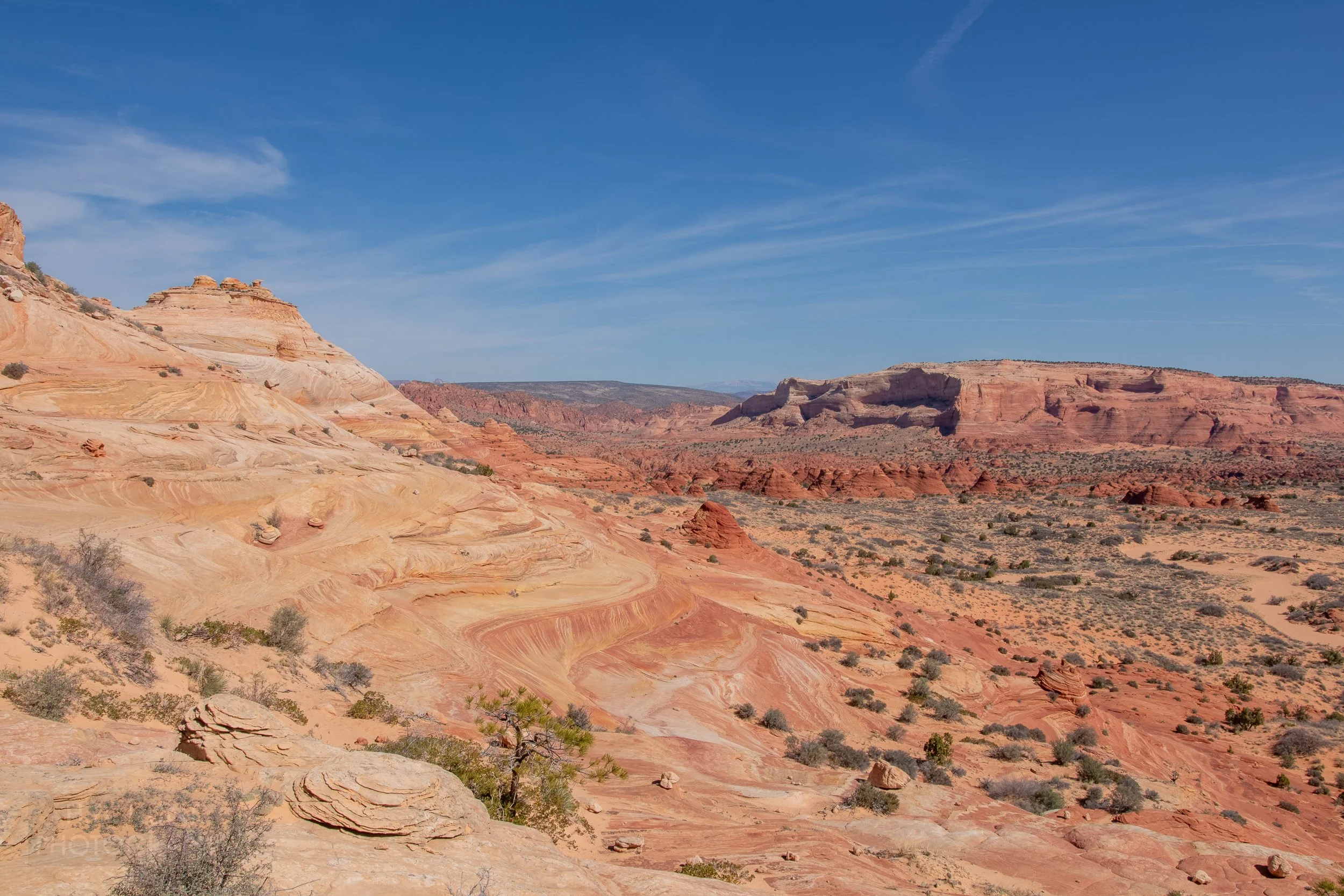 Heavily deformed red sandstone rock is seen at the base of a hill in Coyote Buttes North, Paria Canyon-Vermilion Cliffs Wilderness, Arizona, United States.