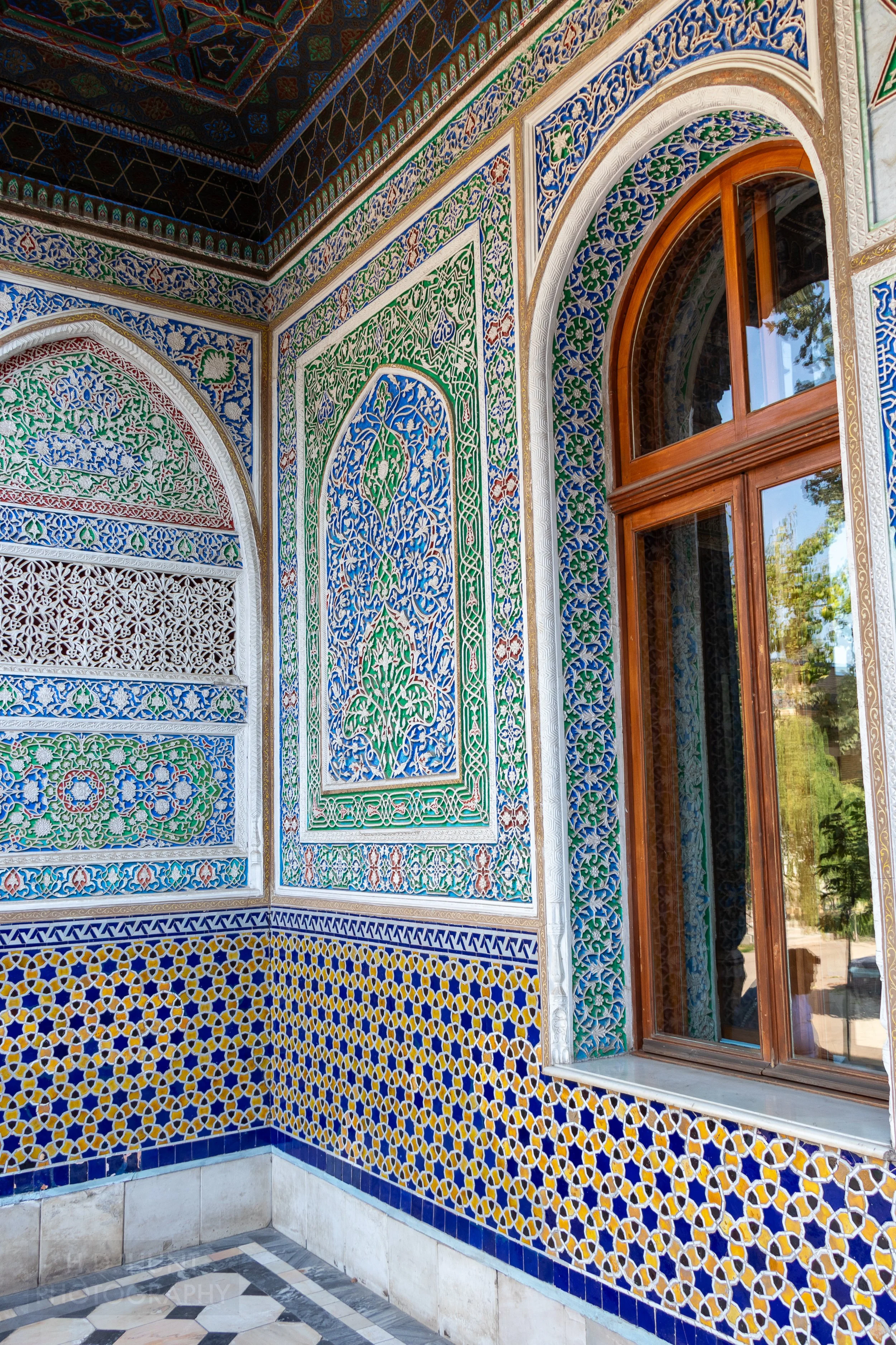 Blue, yellow, green, and red tiles cover a facade within the Museum of Applied Arts, Tashkent, Uzbekistan.