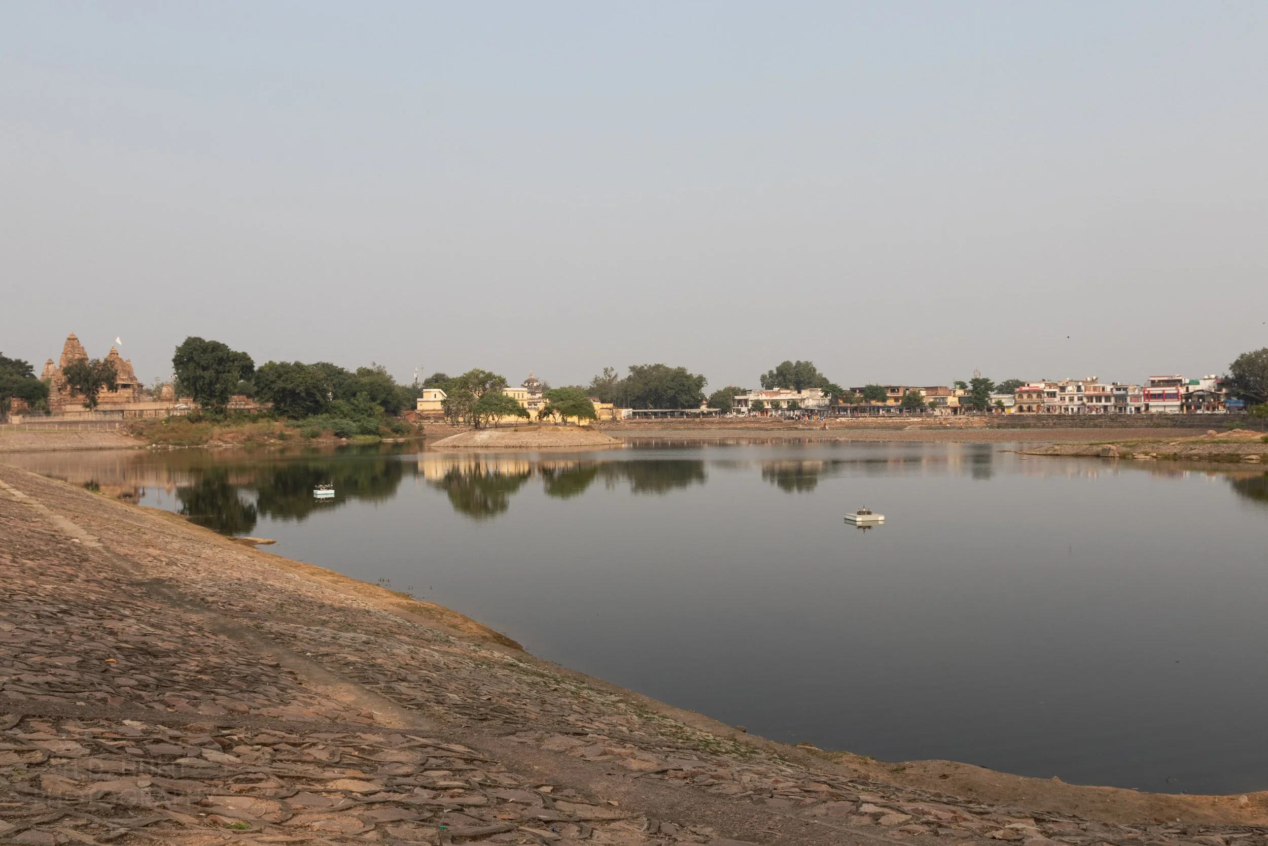 A small pond marks the entrance of the Khajuraho Group of Monuments, India.