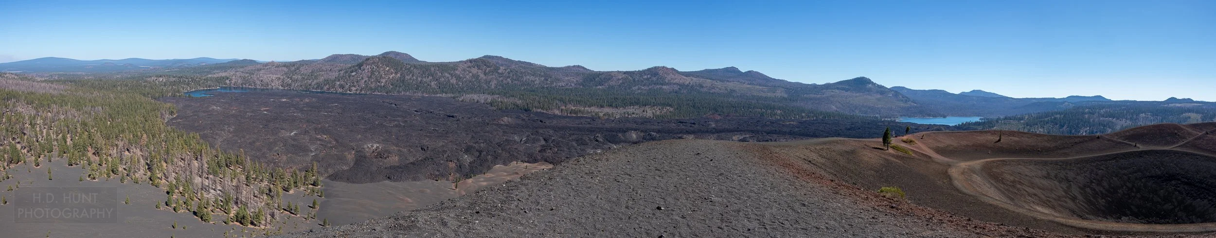 A panoramic view of a large lava flow separating two lakes - referred to as the Fantastic Lava Beds - is seen in Lassen Volcanic National Park, California, United States.