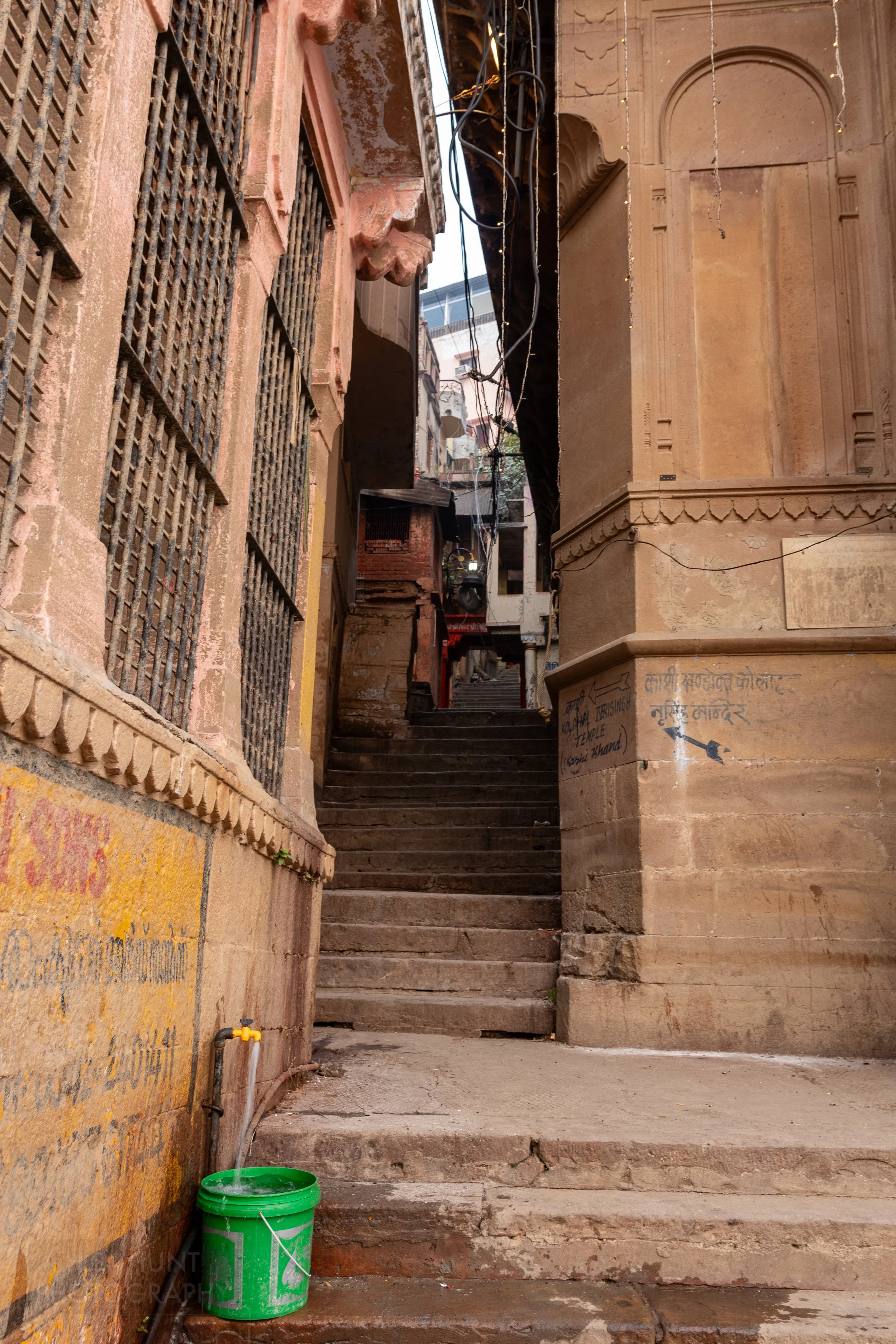 An alleyway with a steep stone staircase, Varanasi, India.