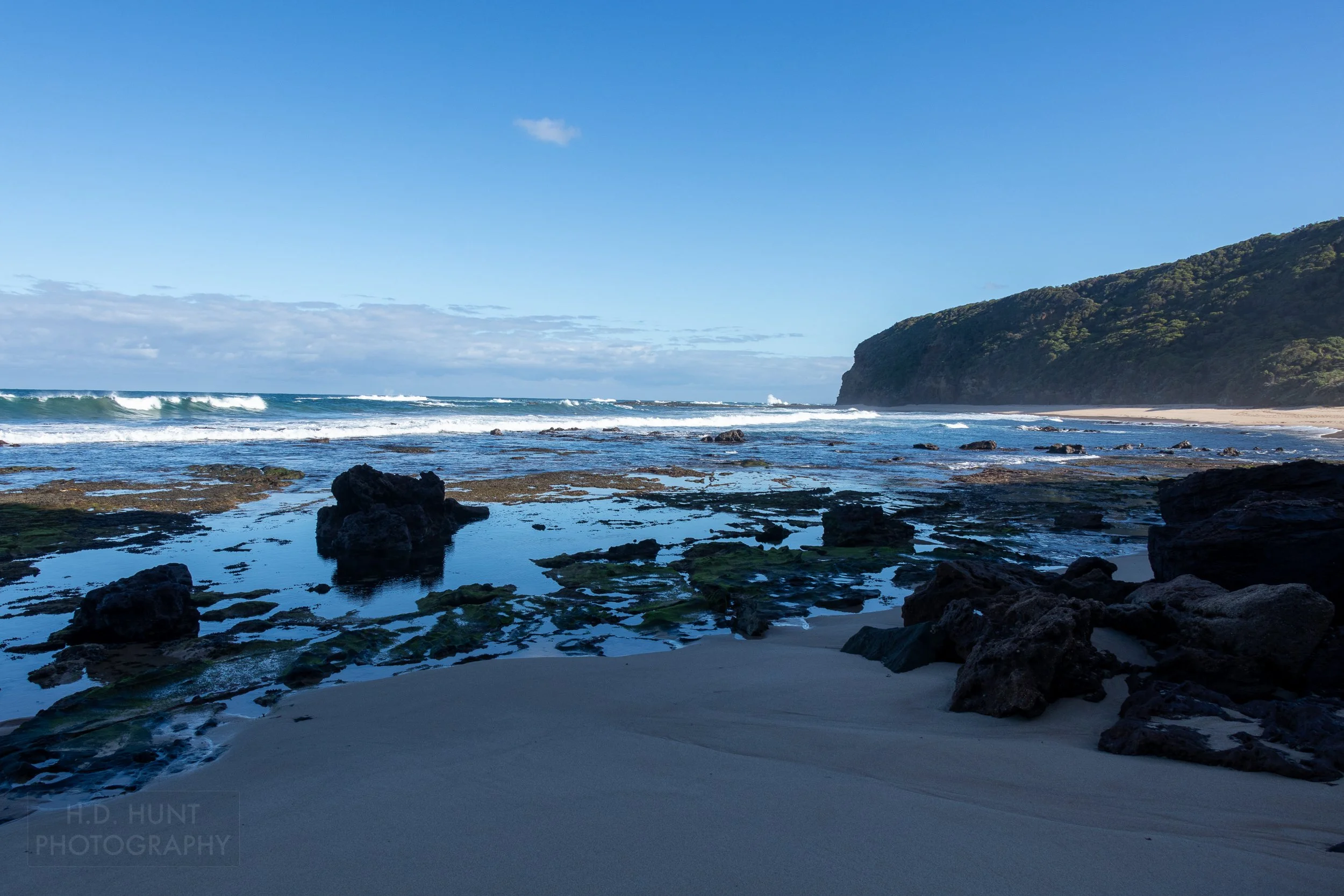Waves roll and crash against rocks on Wreck Beach along The Great Ocean Walk, Victoria, Australia.