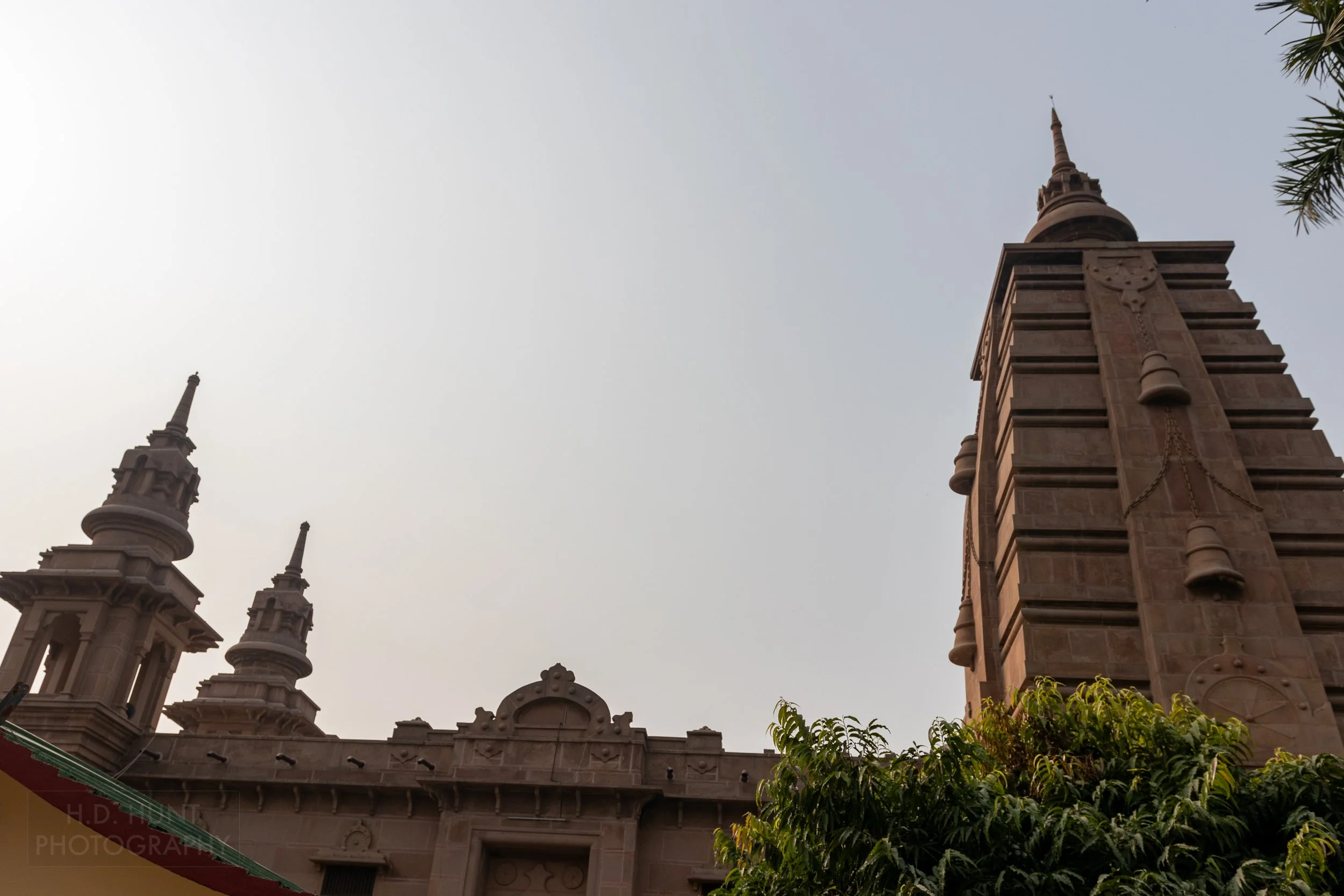 Large stone towers rise above a temple, Sarnath, India.