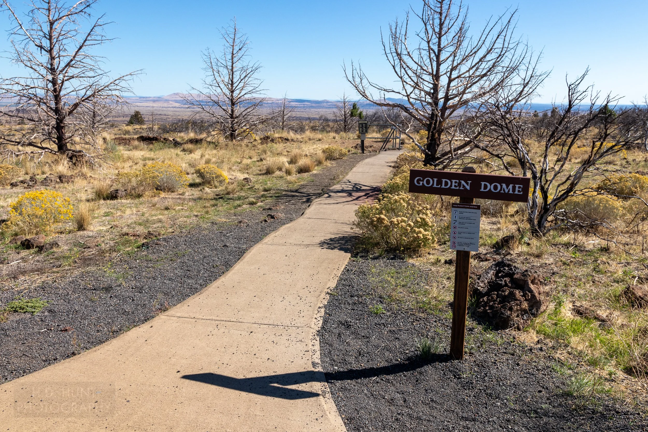 A sign indicates the entrance to a lava tube, Lava Beds National Monument, California, United States.