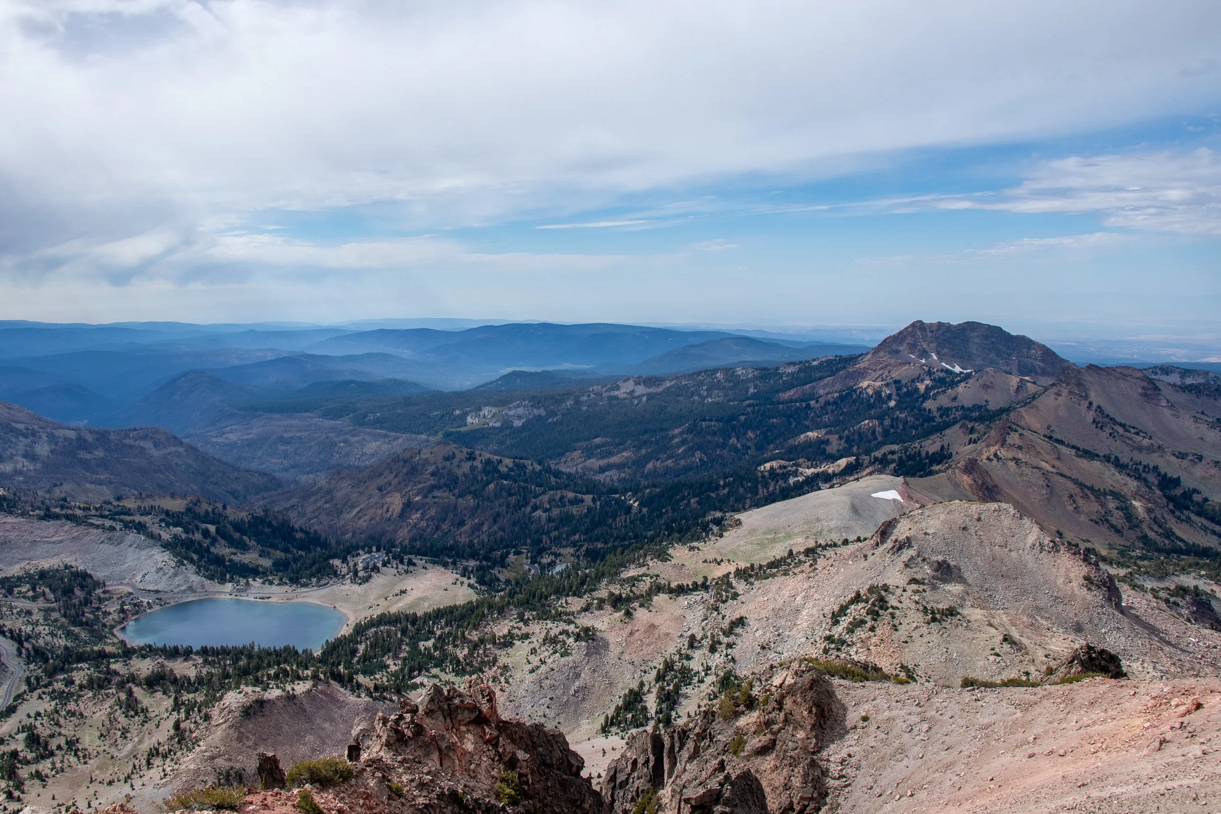 A lake and a mountain - Brokeoff Mountain - can be seen from the peak of Lassen Peak, Lassen Volcanic National Park, California, United States.