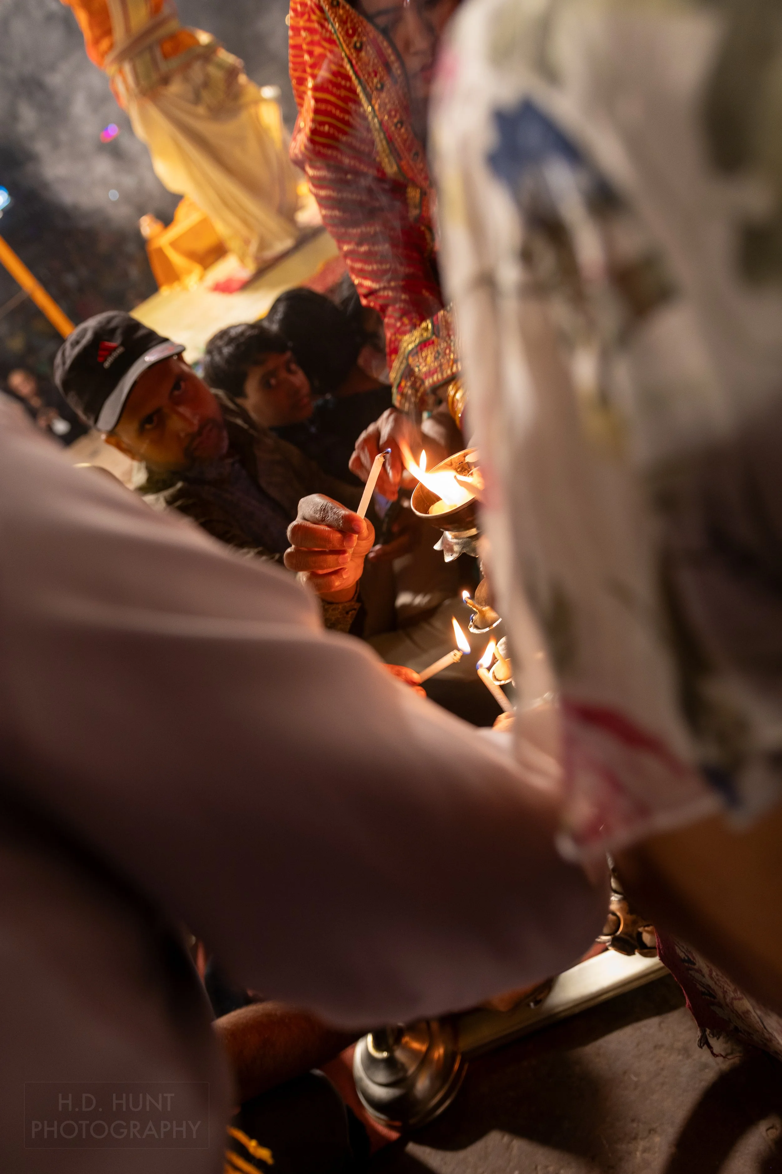 A crowd lights candles during a Hindu religious ceremony called arti, Varanasi, India.