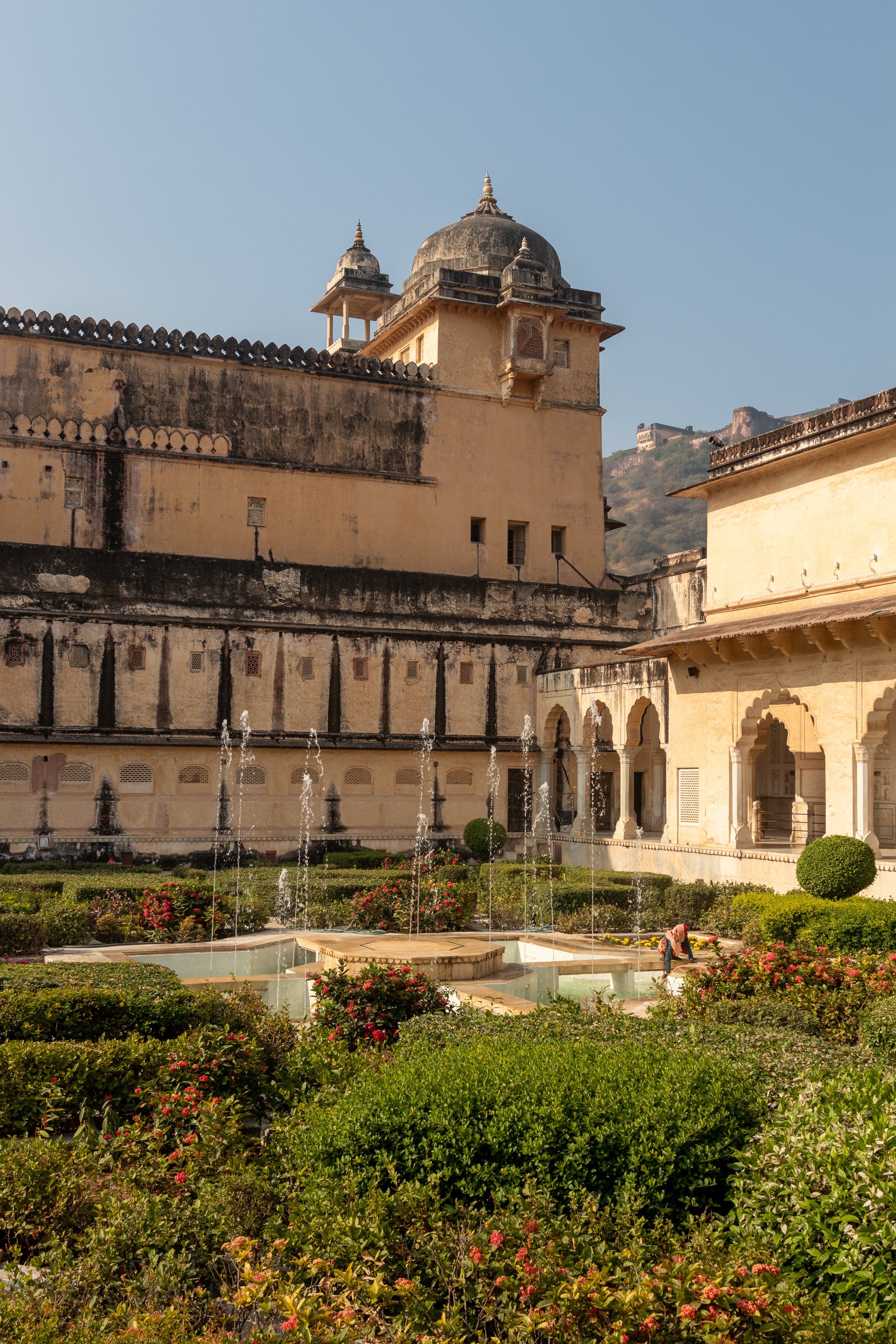 A manicured garden featuring a large central fountain is seen within Amber Fort, Amer, India.