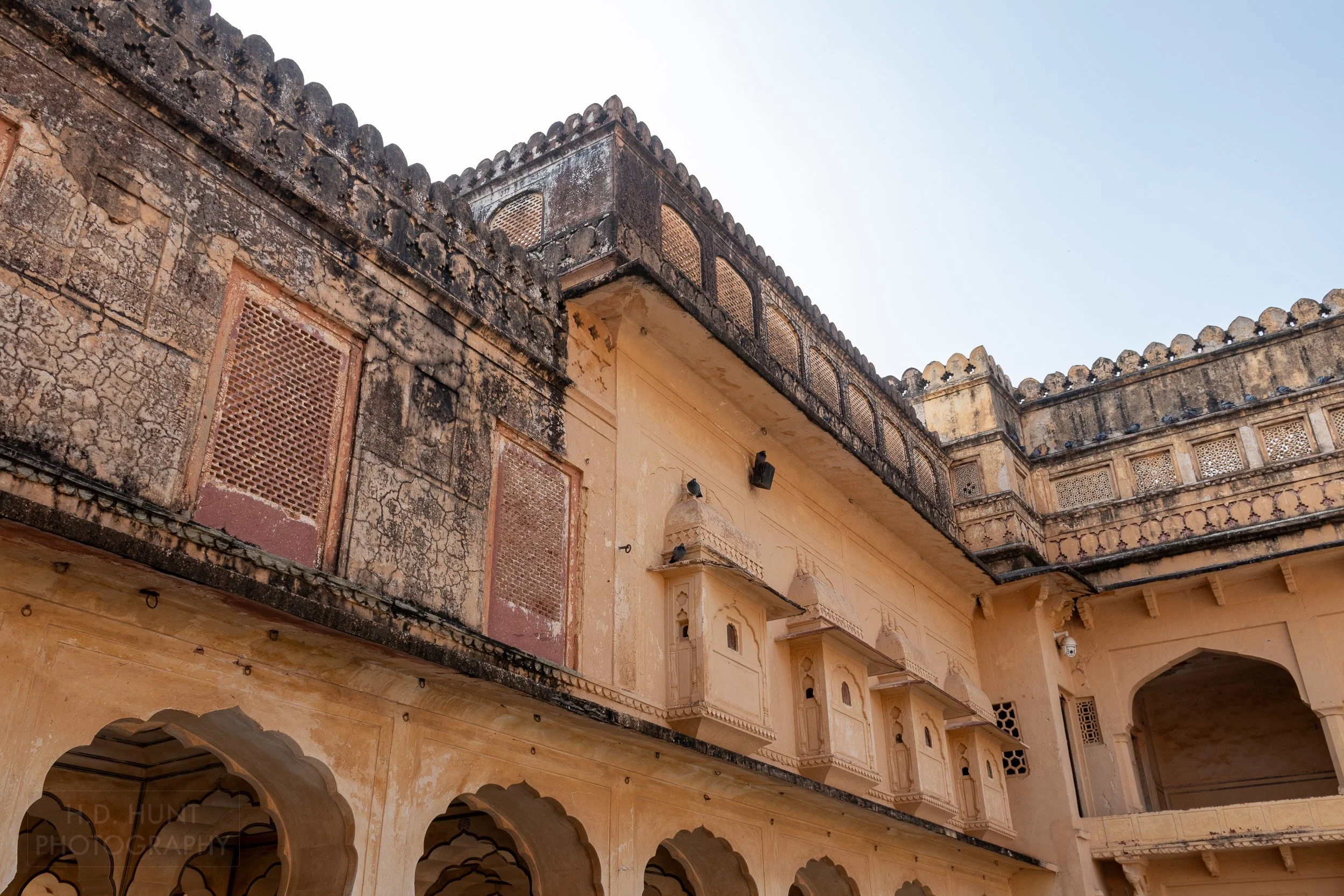 A yellow and black stone facade within Amber Fort, Amer, India.