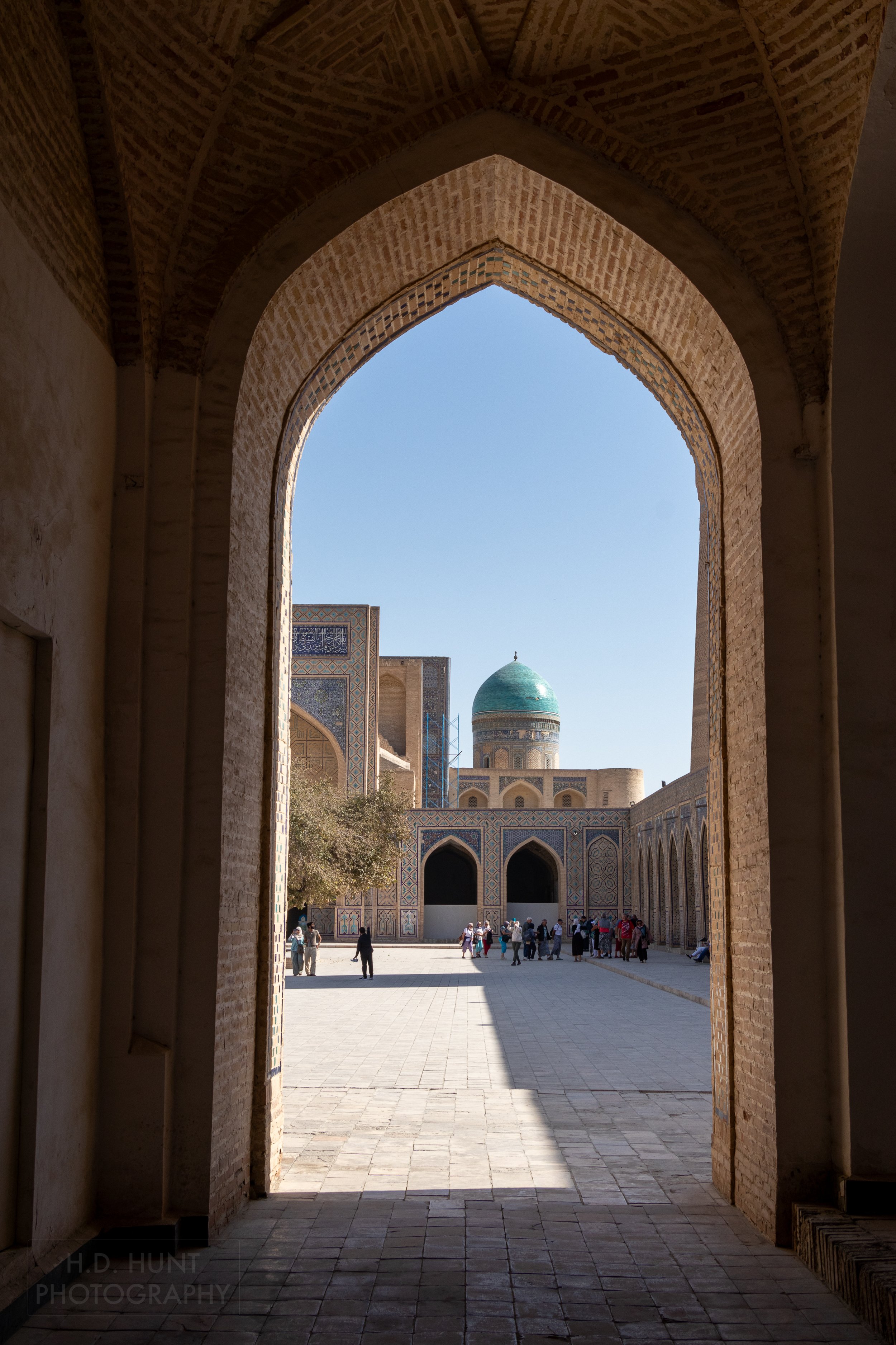 A view across the central courtyard of Kalan Mosque towards the Mir-i-Arab Madrasa, Bukhara, Uzbekistan.