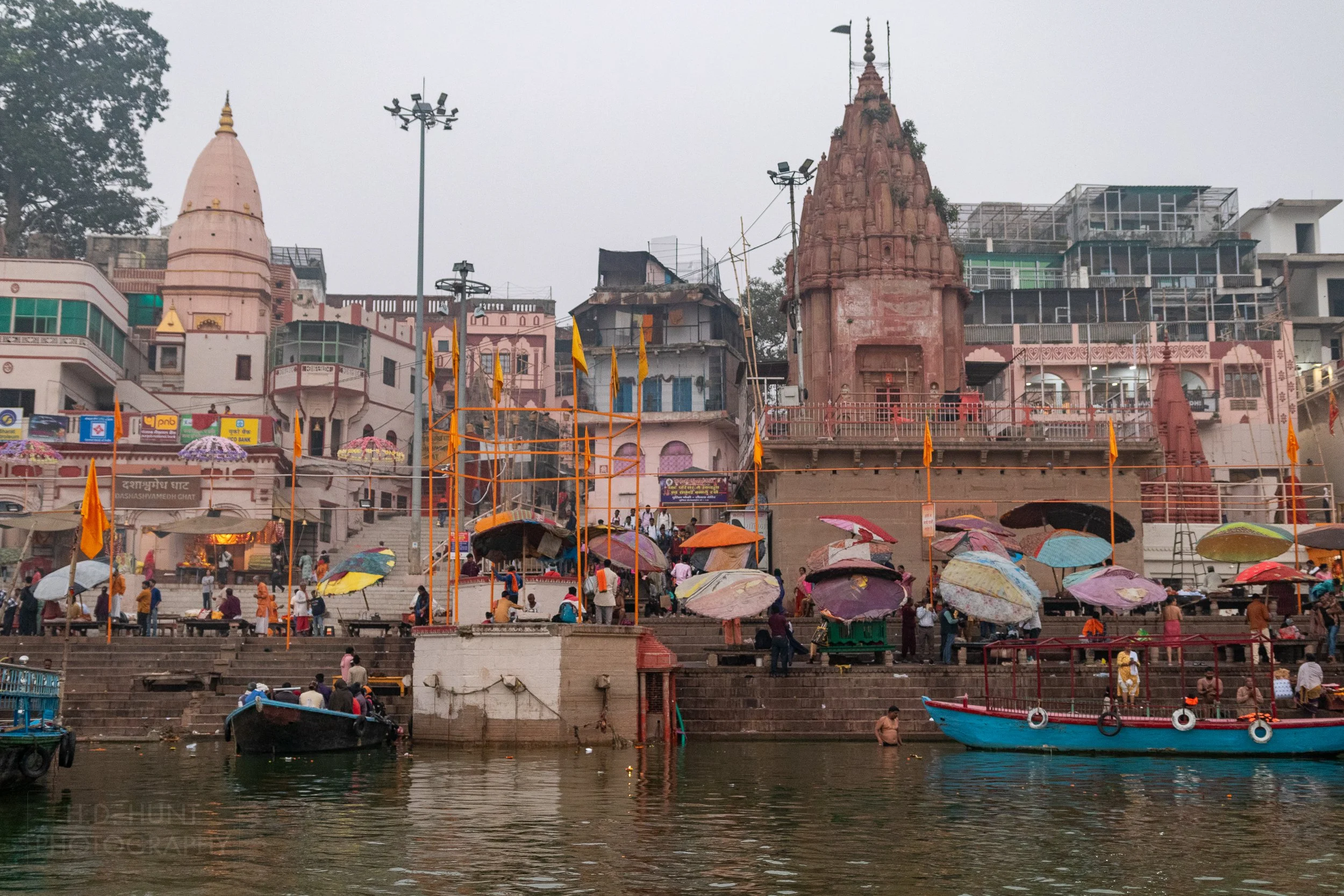 Worshipers congregate and bathe in front of several temples along the Ganges River, Varanasi, India.