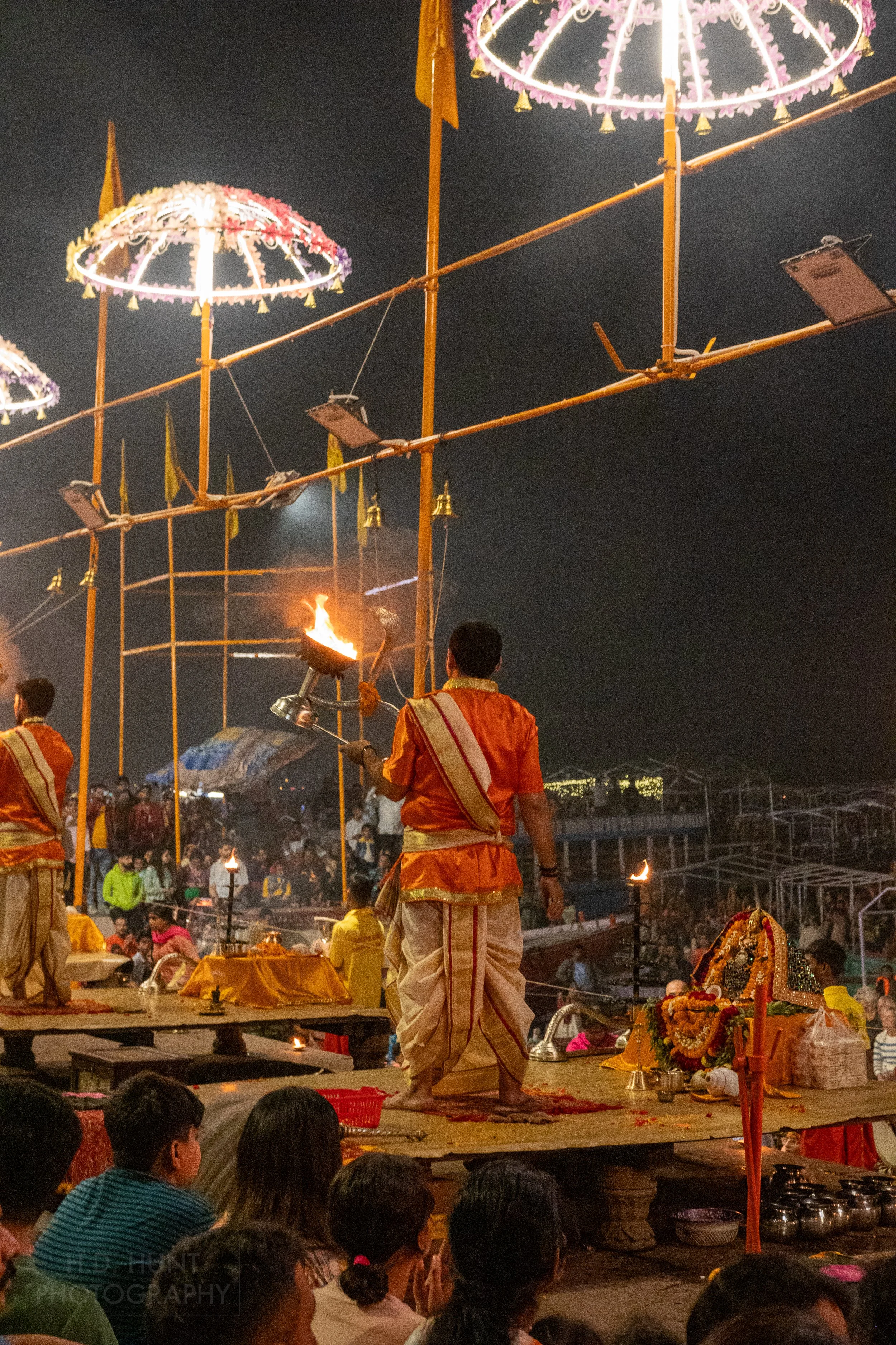 A man holds a large lit lantern during a Hindu religious ceremony called arti, Varanasi, India.
