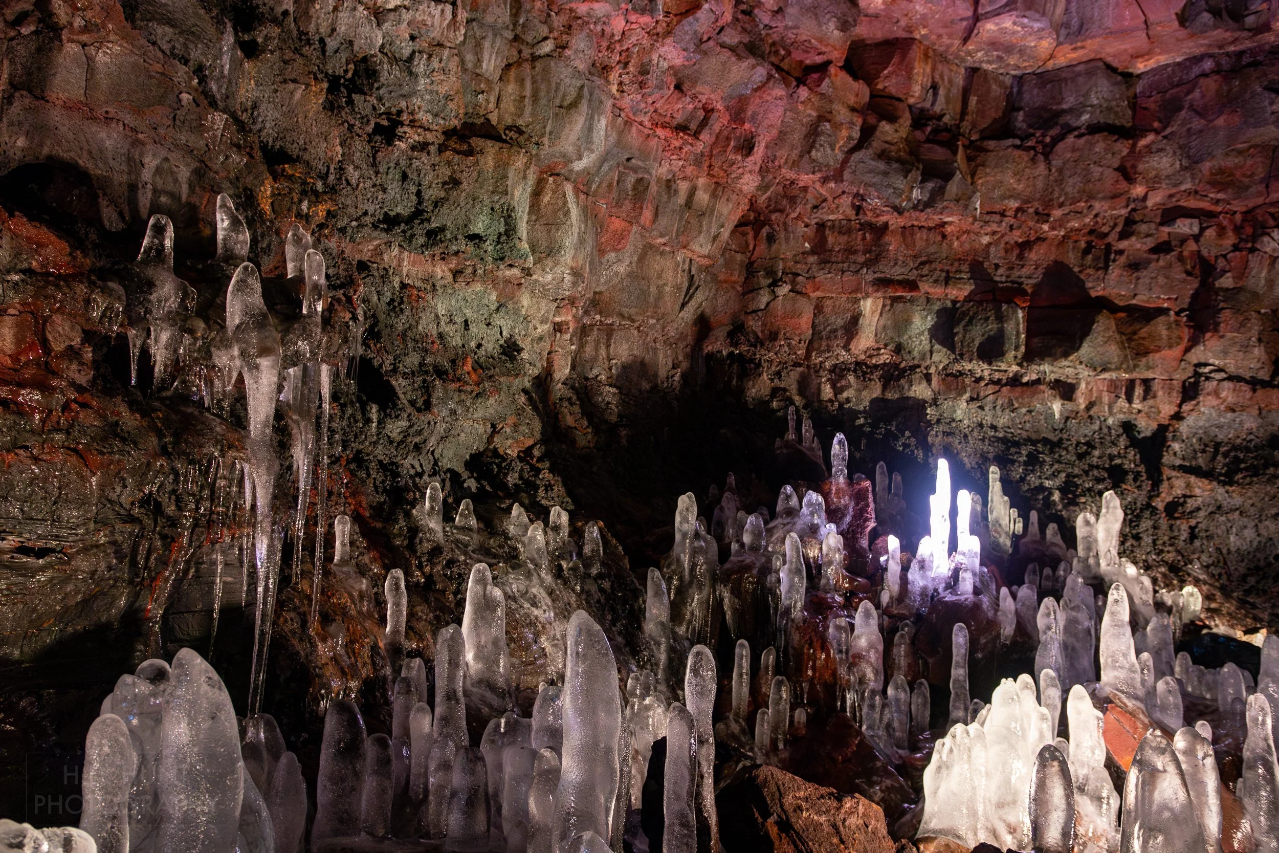 Large ice columns form on the volcanic floor of the lava tube Raufarhólshellir, Iceland.