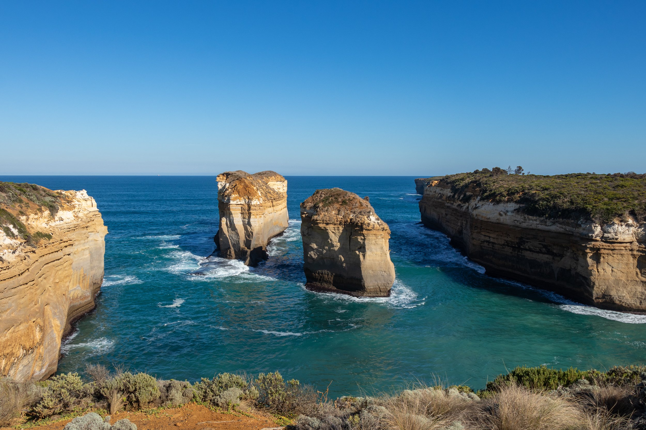 Two limestone stacks - the remains of the Island Archway - are seen in the blue waters of the Southern Ocean at Loch Ard Gorge, Victoria, Australia.