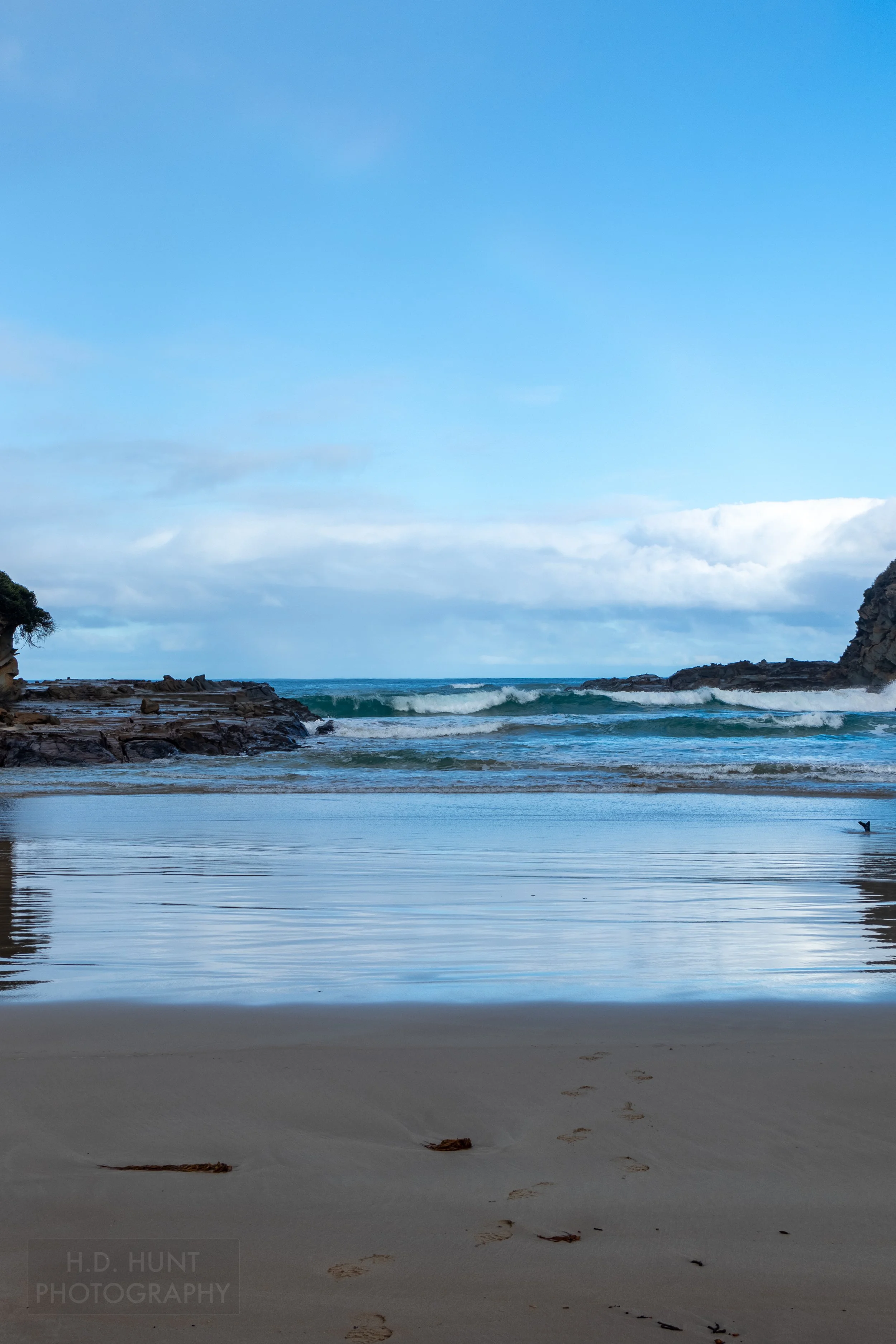 Waves splash into a small cove at Parker Inlet along The Great Ocean Walk, Victoria, Australia.