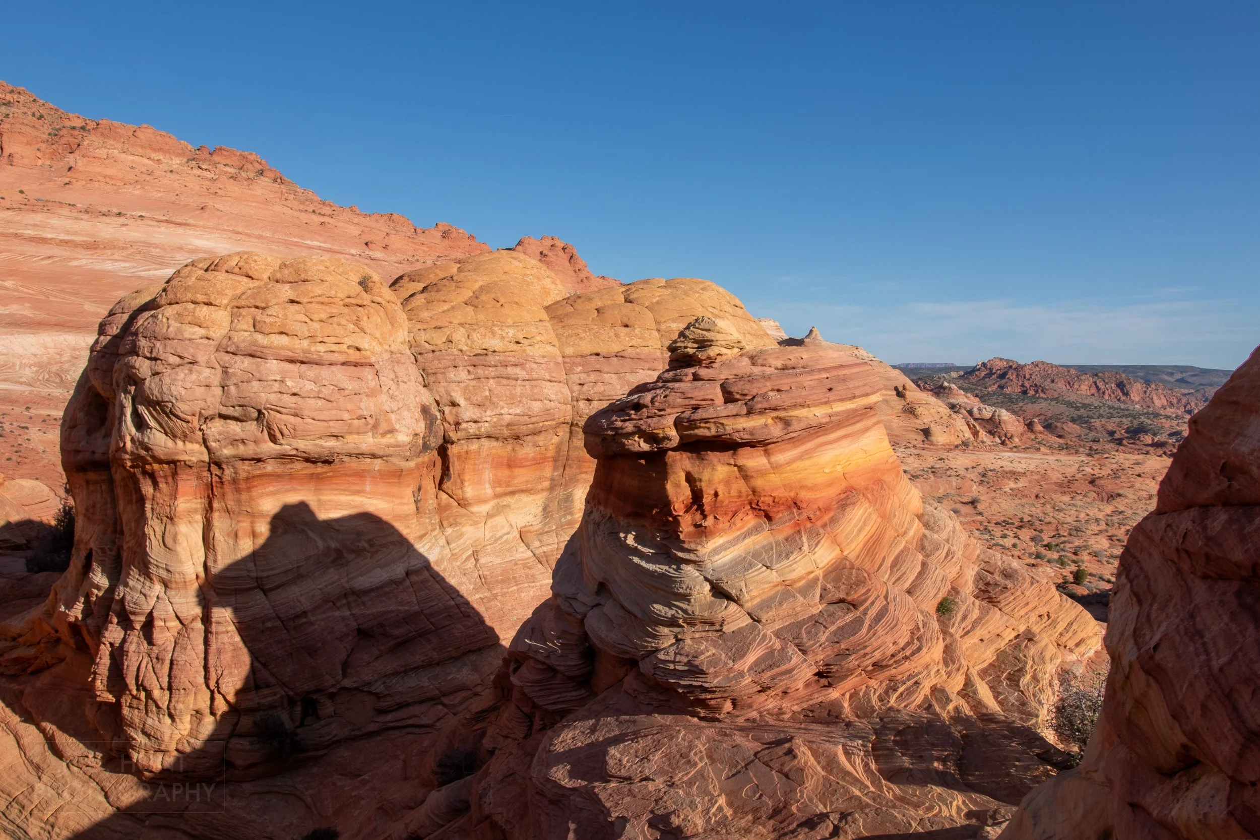 Red, yellow, tan, and pink sandstone cliffs are seen in Coyote Buttes North, Paria Canyon-Vermilion Cliffs Wilderness, Arizona, United States.