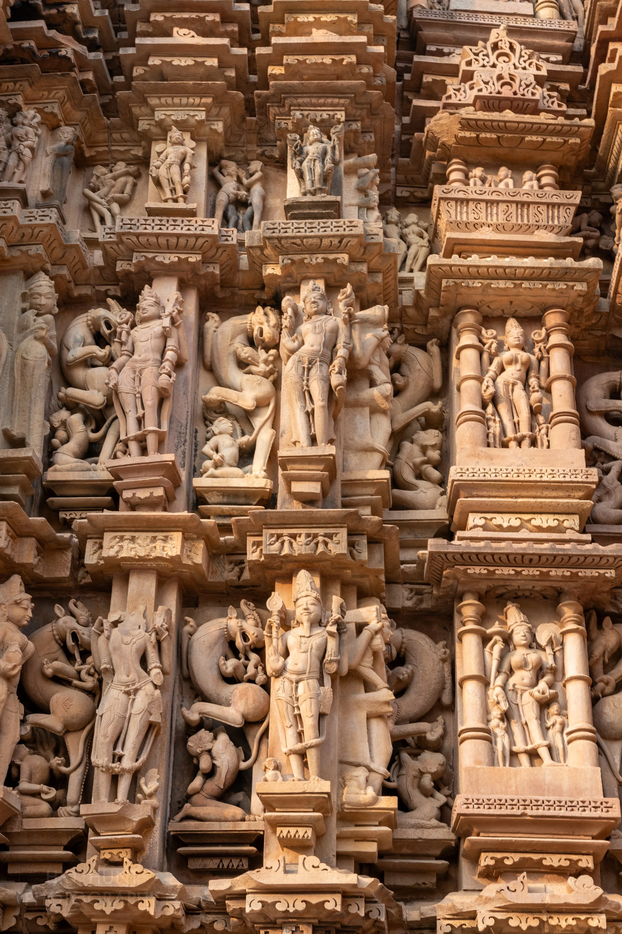 Close-up of the stone carvings adoring Kandariya Mahadeva, Khajuraho Group of Monuments, India.