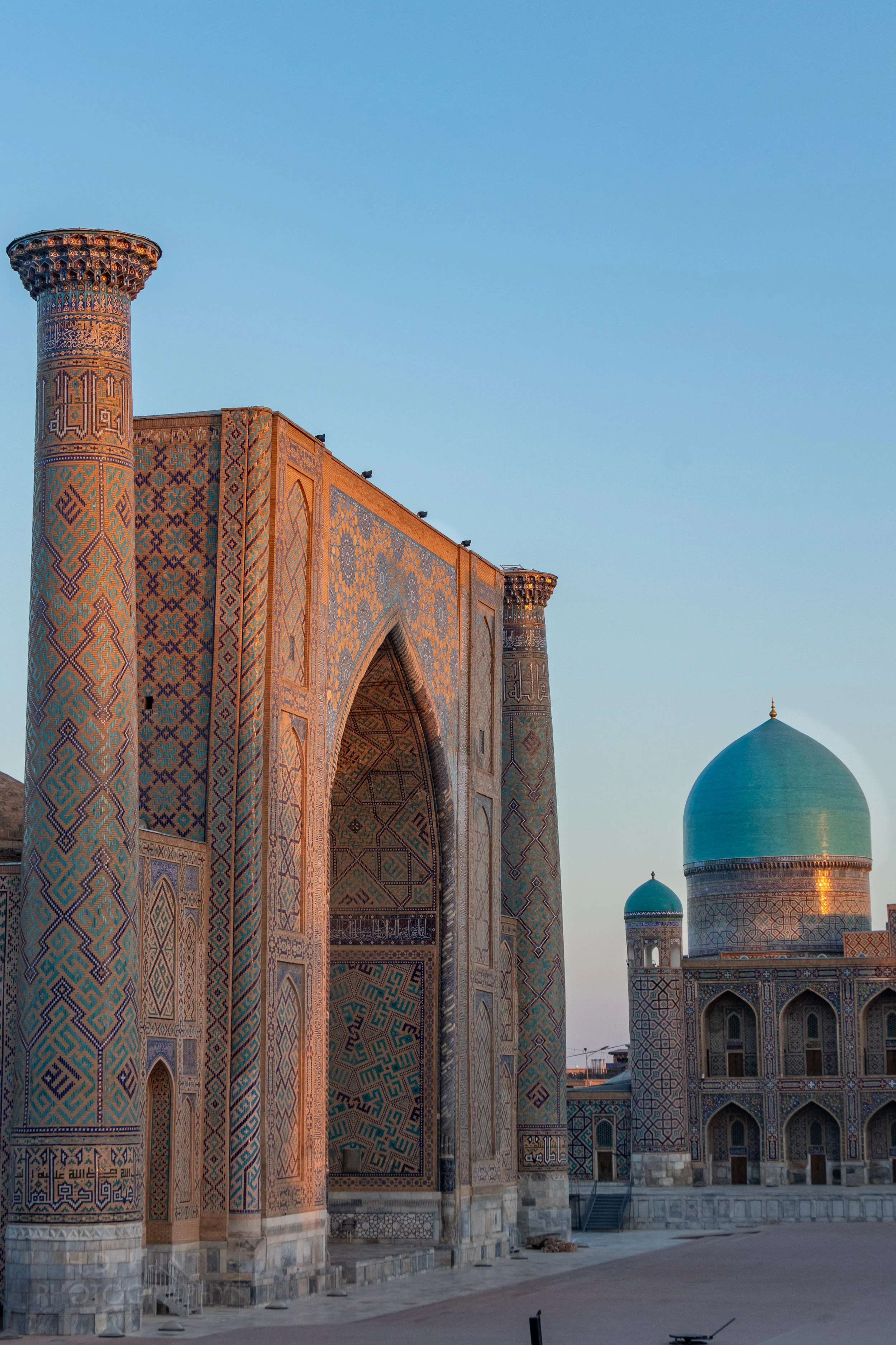 The Ulugh Beg Madrasa in the Registan square illuminated at sunrise, Samarkand, Uzbekistan.