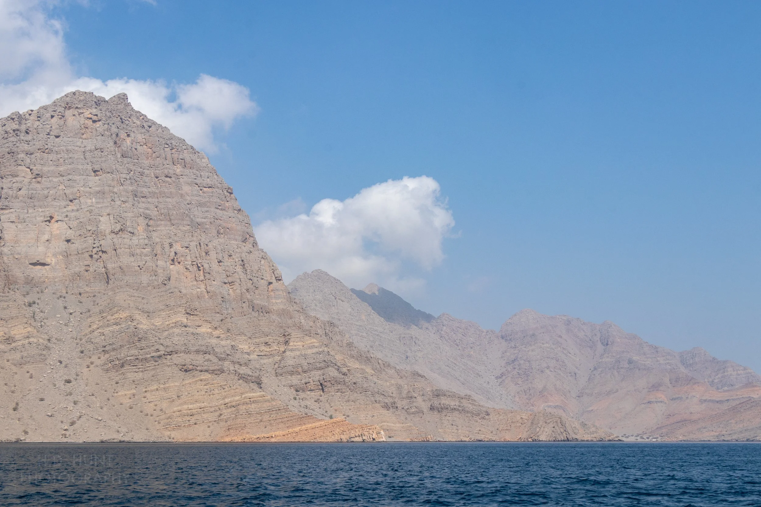 The mountains of the Musandam Peninsula, Oman, fall sharply into the sea.
