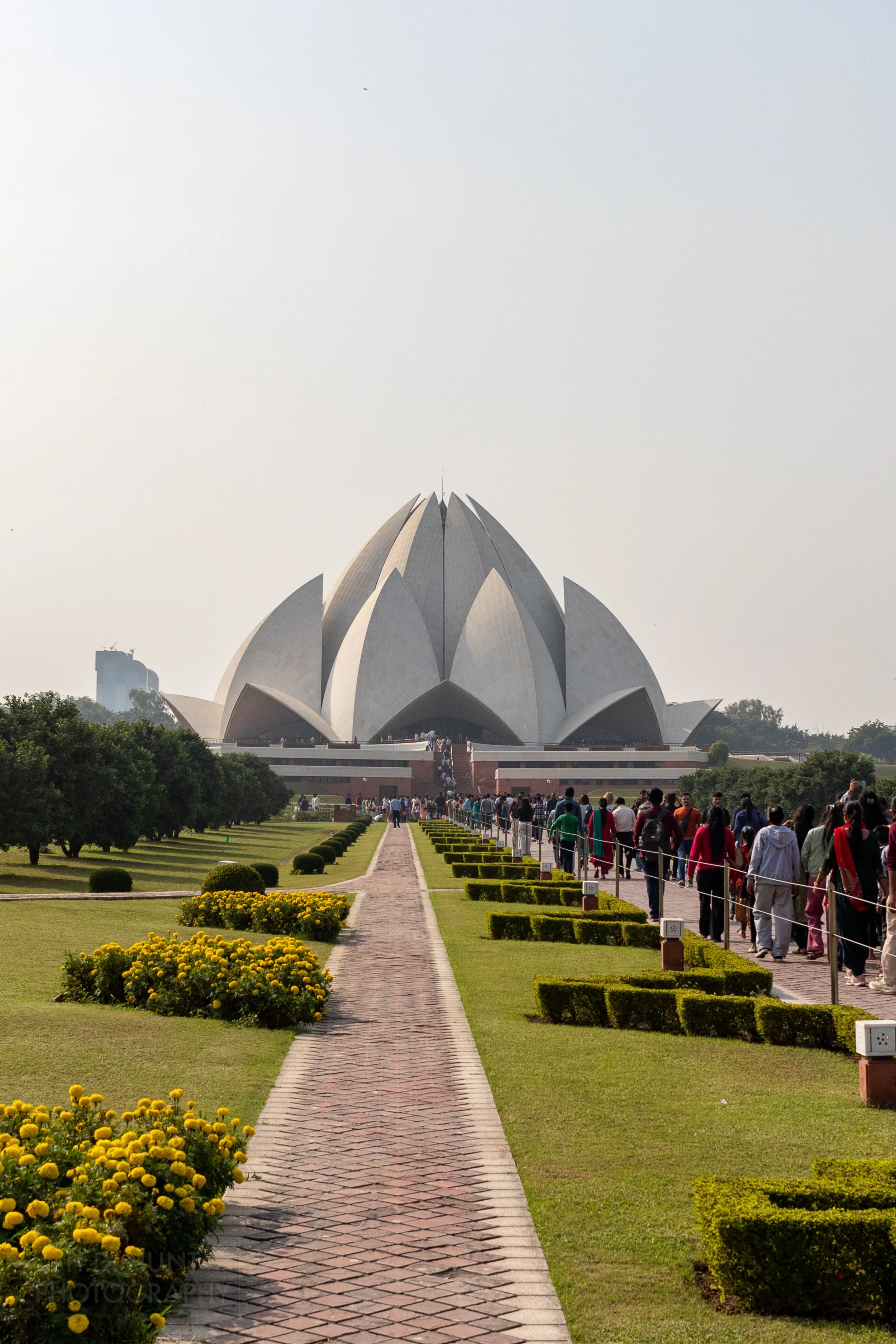 Visitors line up to visit the white stone Lotus Temple, Delhi, India.