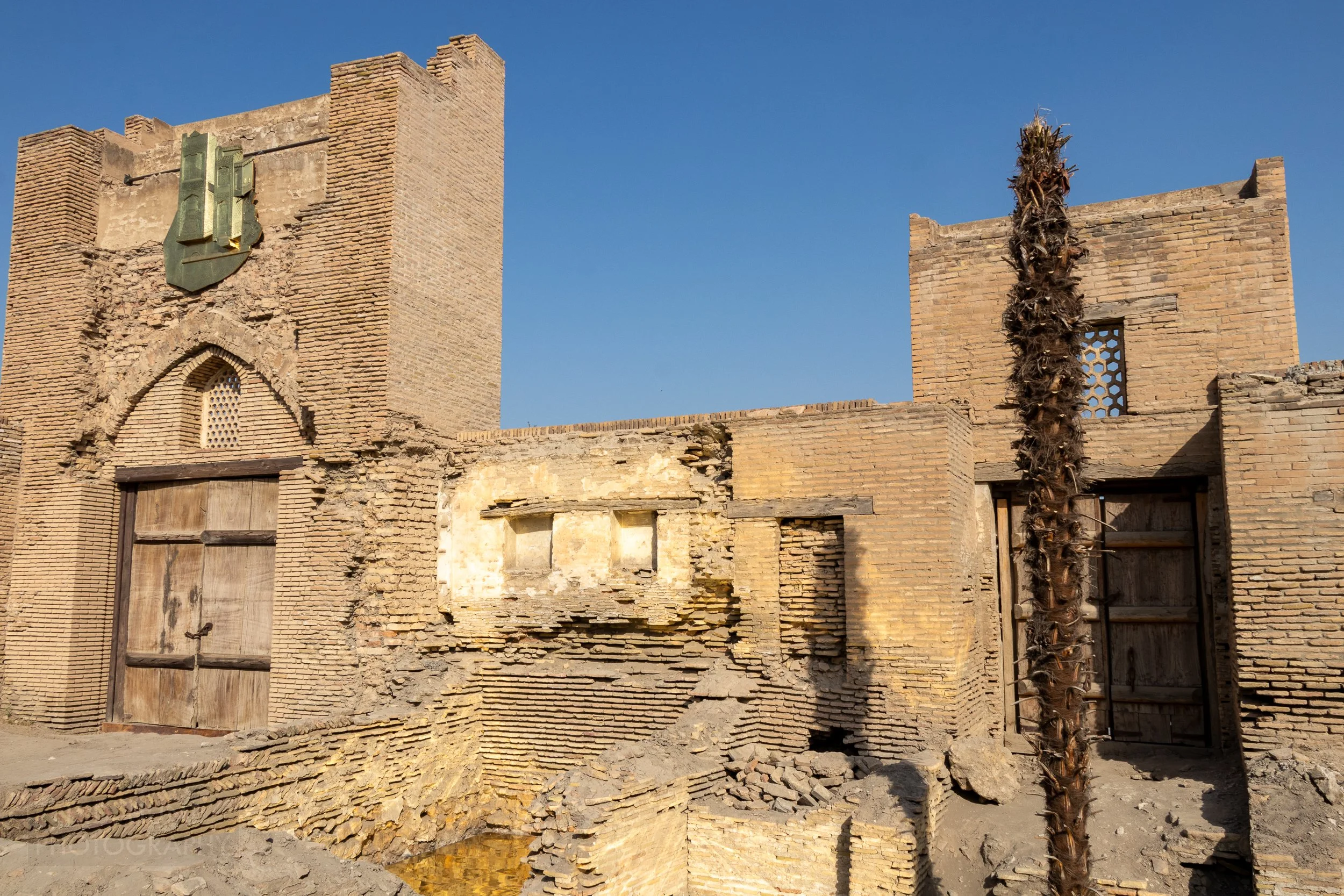 Ruined stone interior walls of the Ulugbek Tamakifurush caravanserai in Bukhara, Uzbekistan.