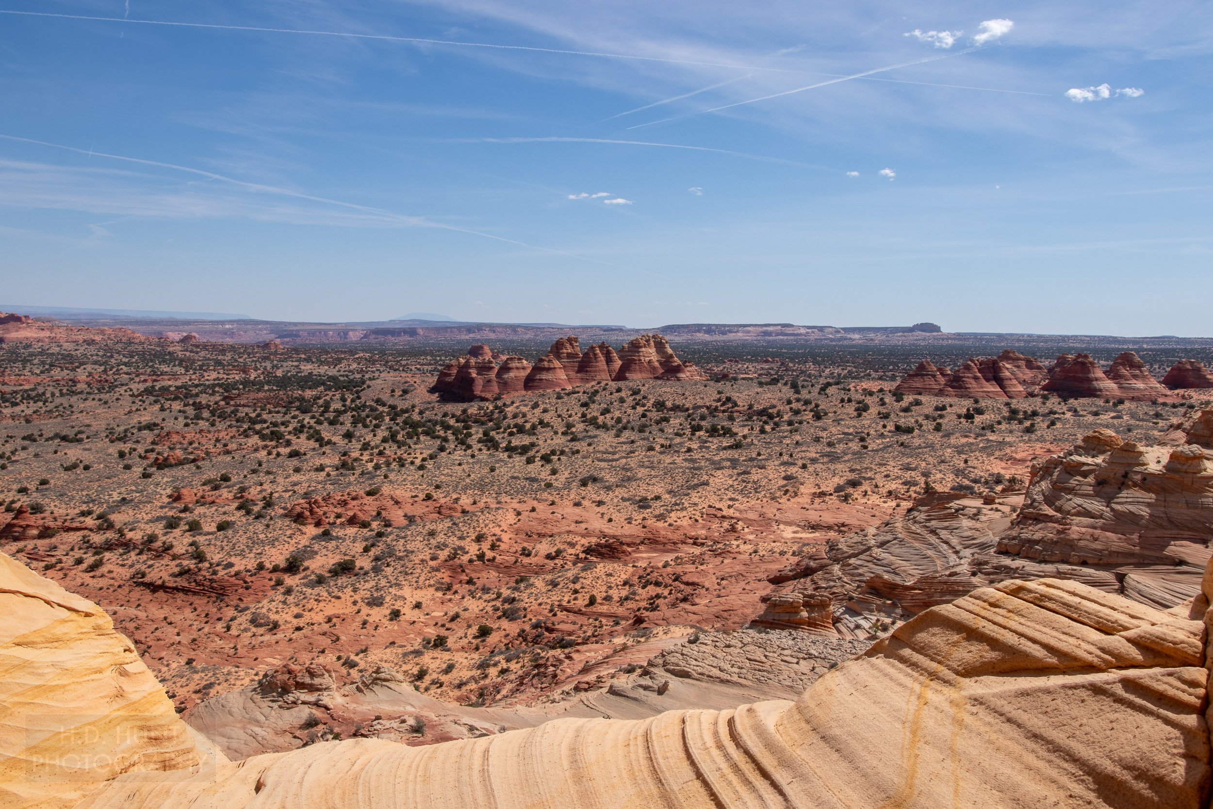 Two clusters of red and white sandstone pillars - the North Teepees and the South Teepees - are seen from a cliff in Coyote Buttes North, Paria Canyon-Vermilion Cliffs Wilderness, Arizona, United States.