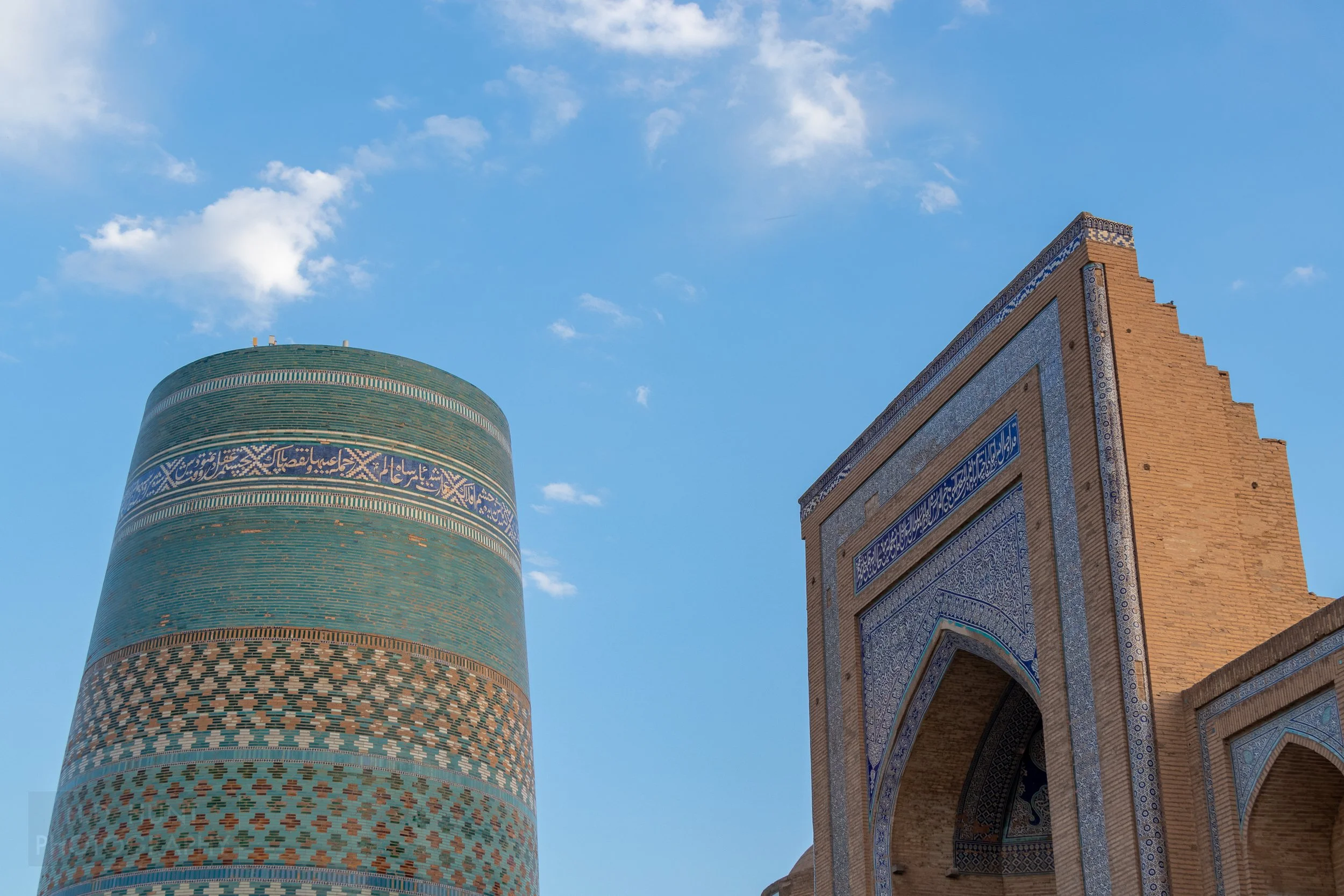 The tiled Kalta Minor stands opposite the gate of the Muhammad Amin Khan Mosque in Khiva, Uzbekistan.