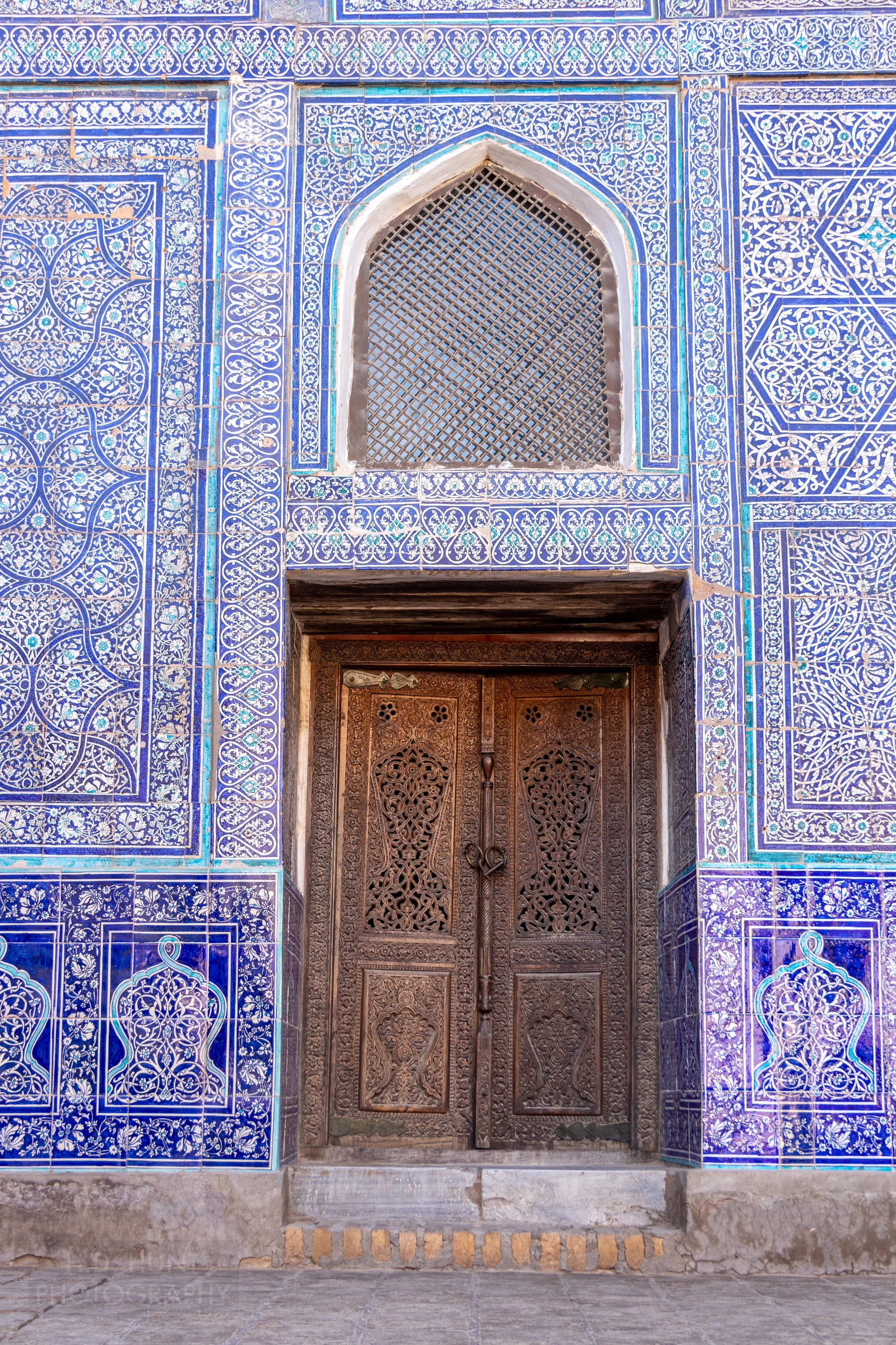 An ornate door surrounded by tile work is seen in the Reception Courtyard of the Kuhna Ark, Khiva, Uzbekistan.
