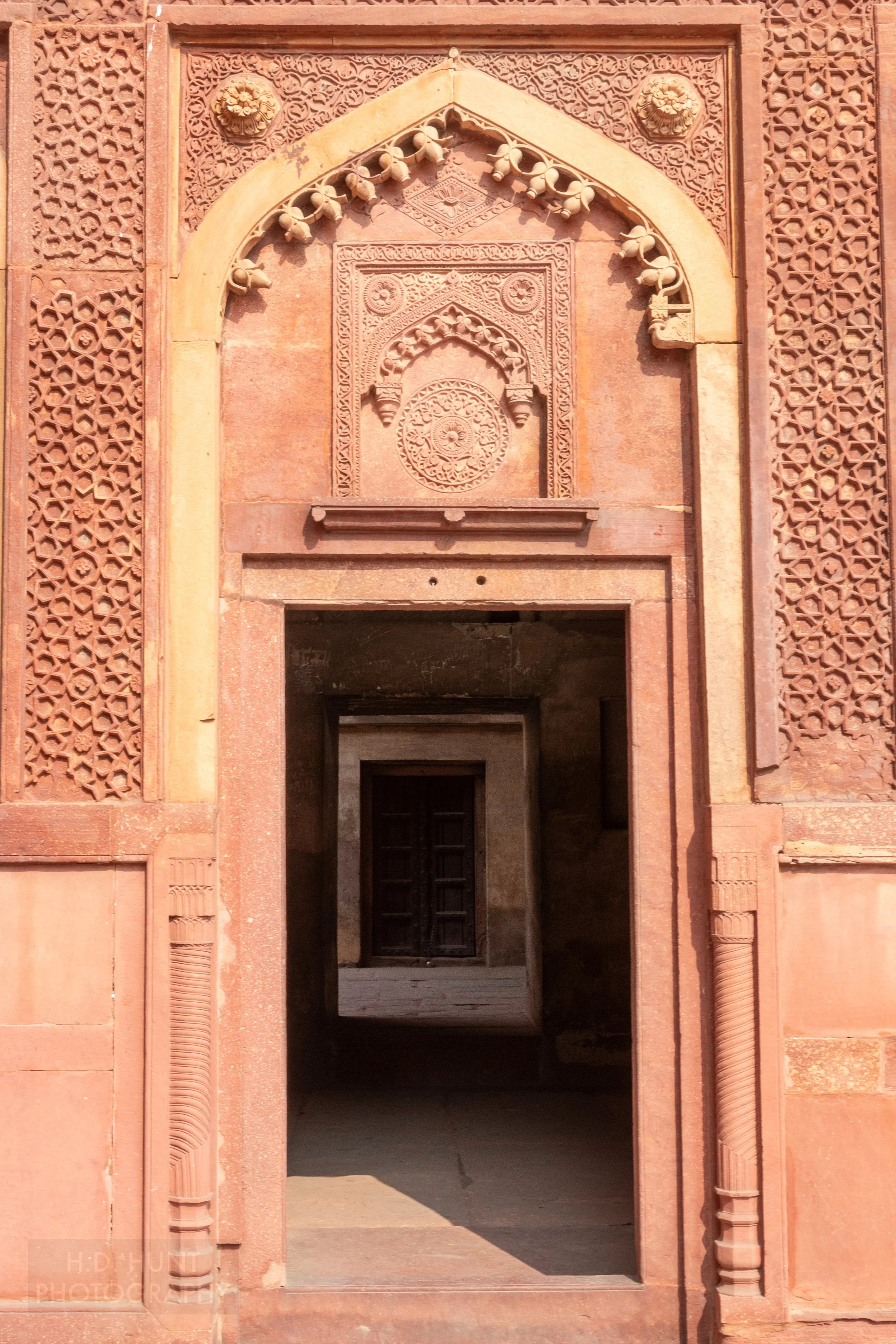 Several doorways are seen through a large red sandstone wall, Agra Fort, Agra, India.