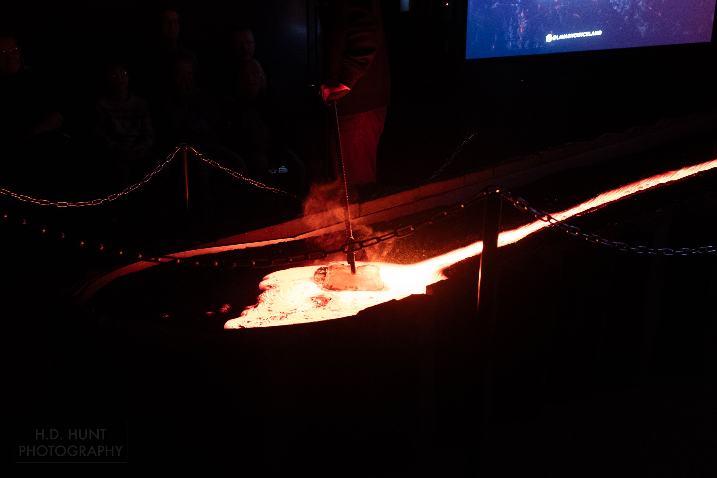 Molten lava is moved by a piece of steel rebar at the Lava Show, Vik i Myrdal, Iceland.