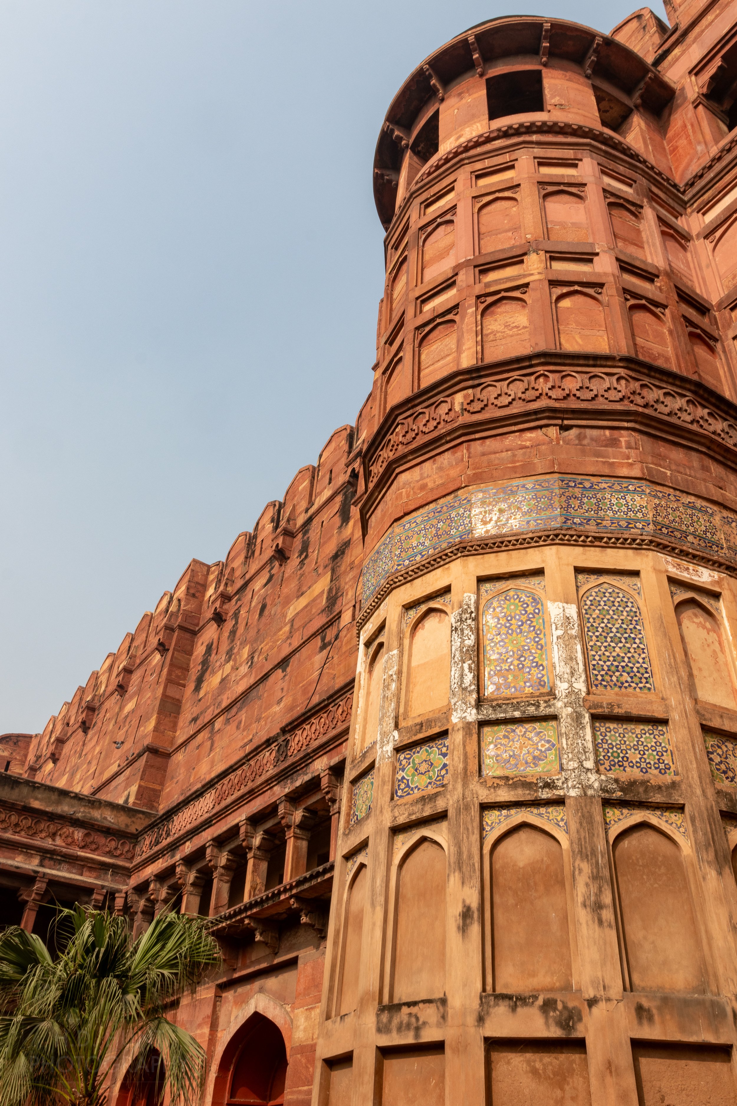 A red sandstone exterior wall and intricate tile work are seen on the outside of Agra Fort, Agra, India.