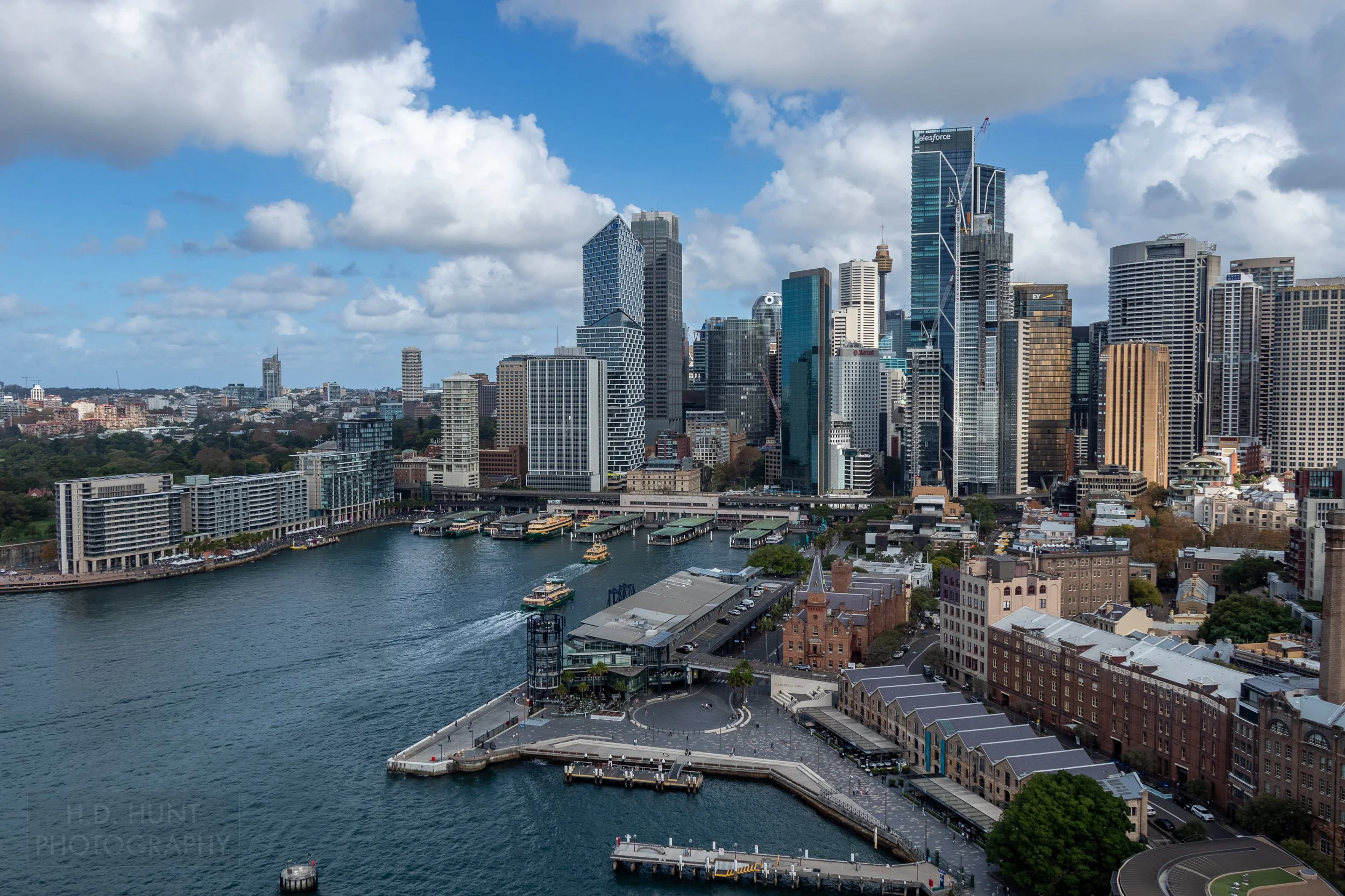 Several large skyscrapers loom over the Circular Quay port and The Rocks neighborhood, Sydney, Australia.
