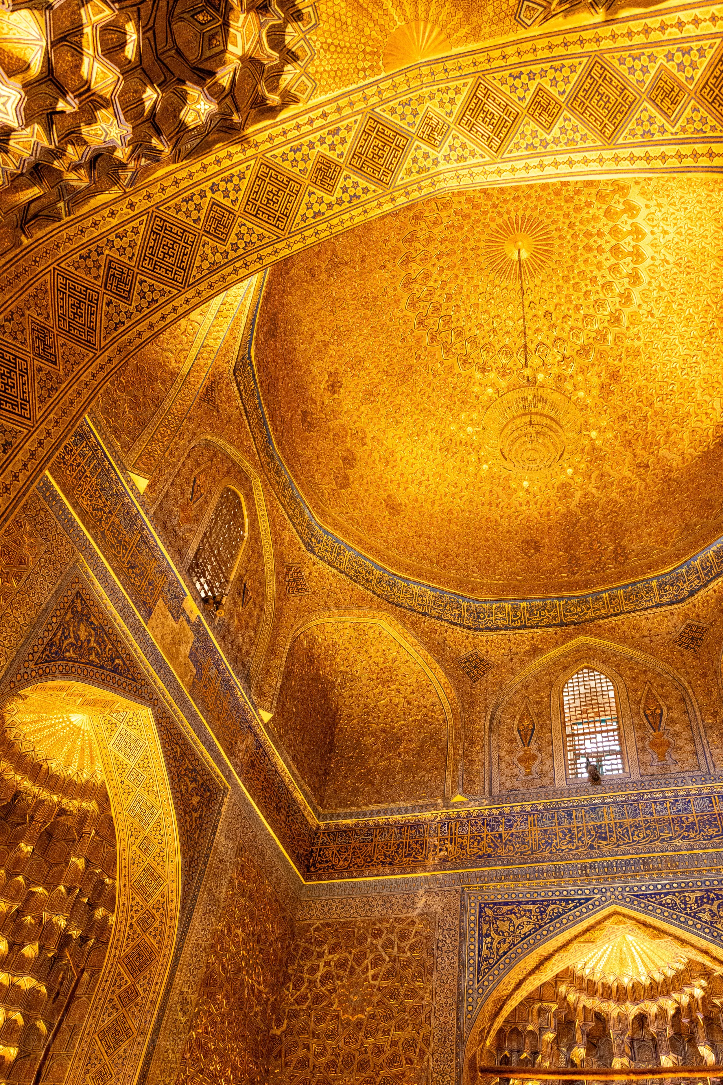 The golden interior of the central dome of the Amir Temur Mausoleum in Samarkand, Uzbekistan.