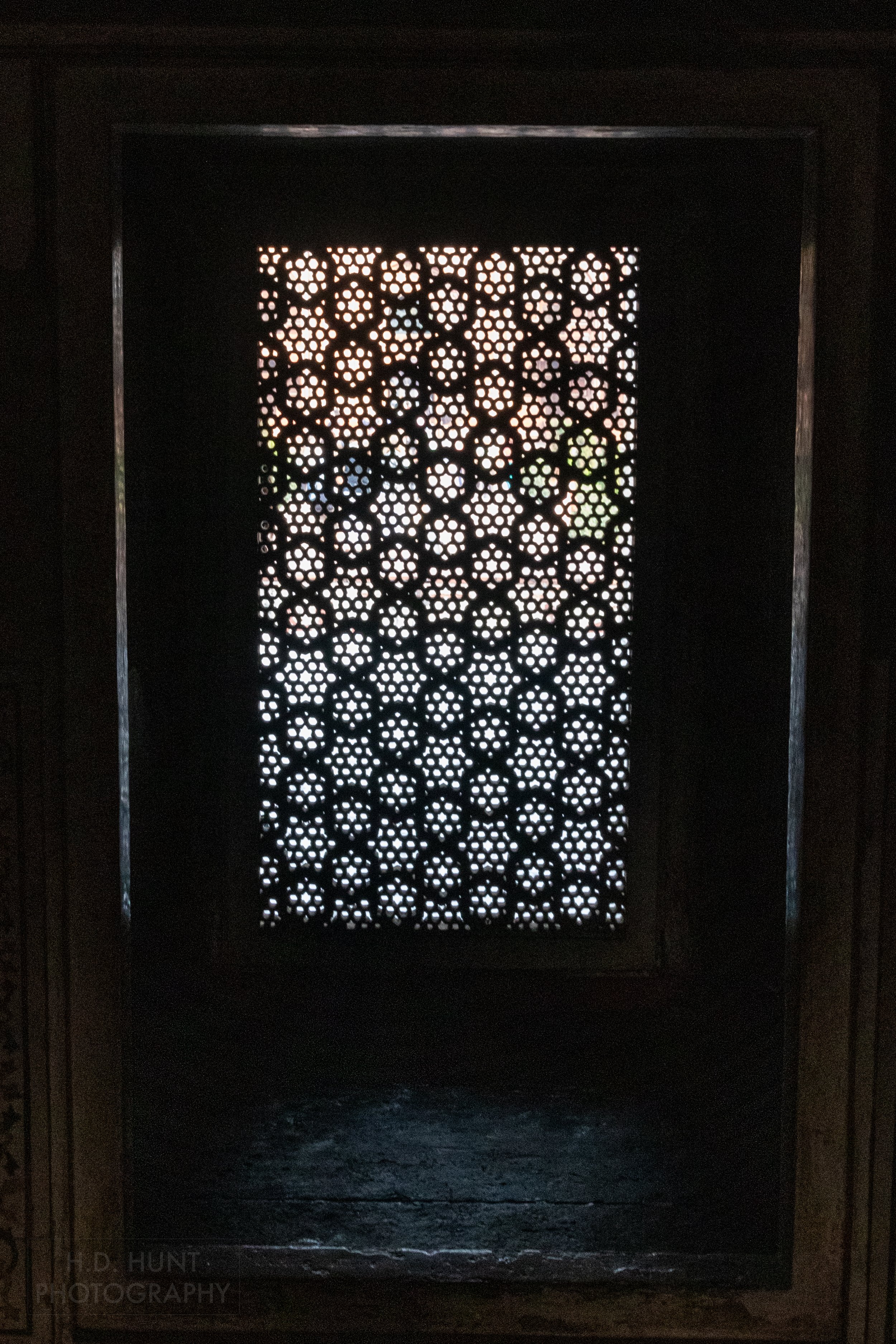 An intricately carved silhouetted stone window screen allows light to enter, Tomb of I’timad-ud-Daulah, Agra, India.