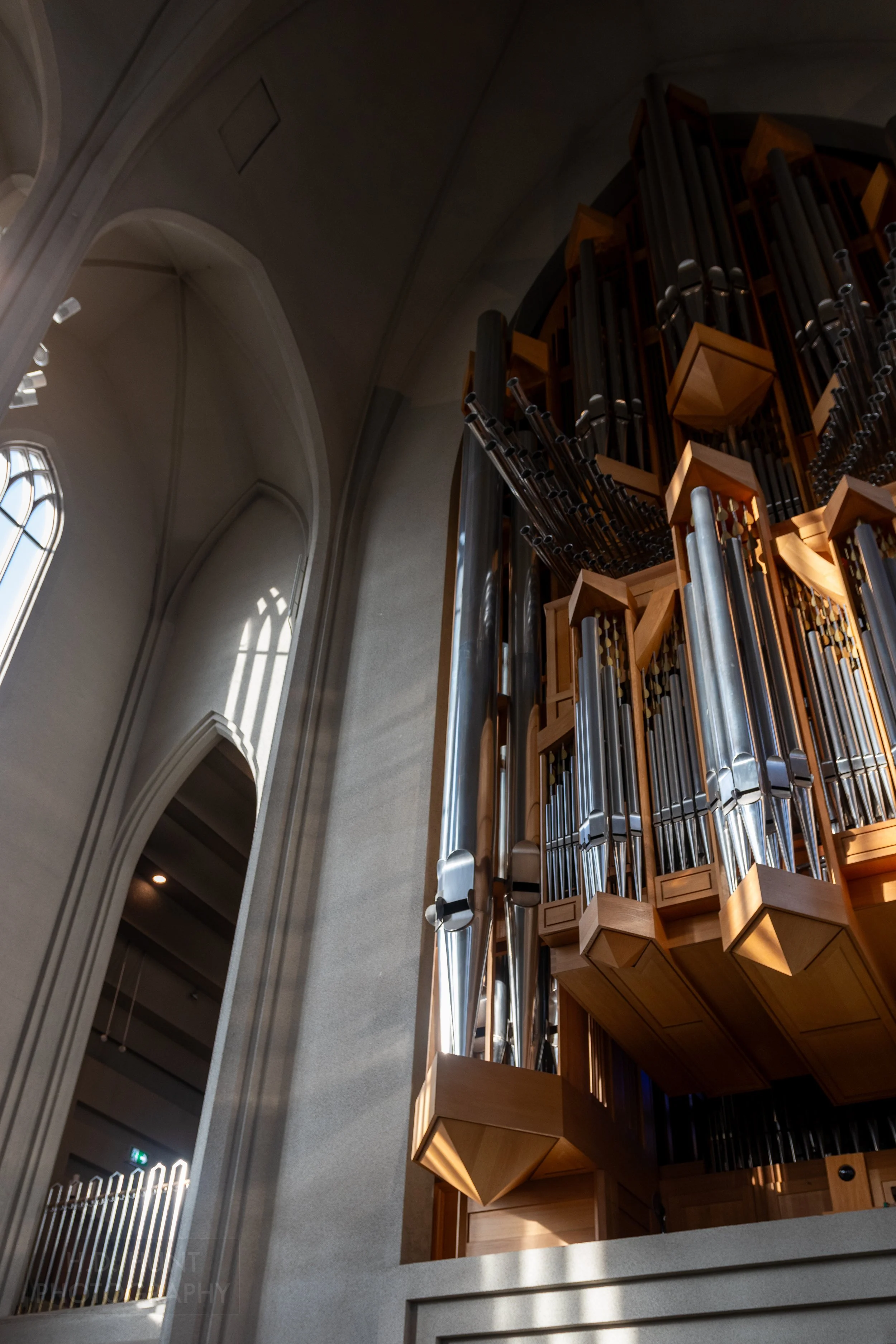 Sunlight strikes the pipes of a pipe organ inside Hallgrímskirkja, Reykjavík, Iceland.