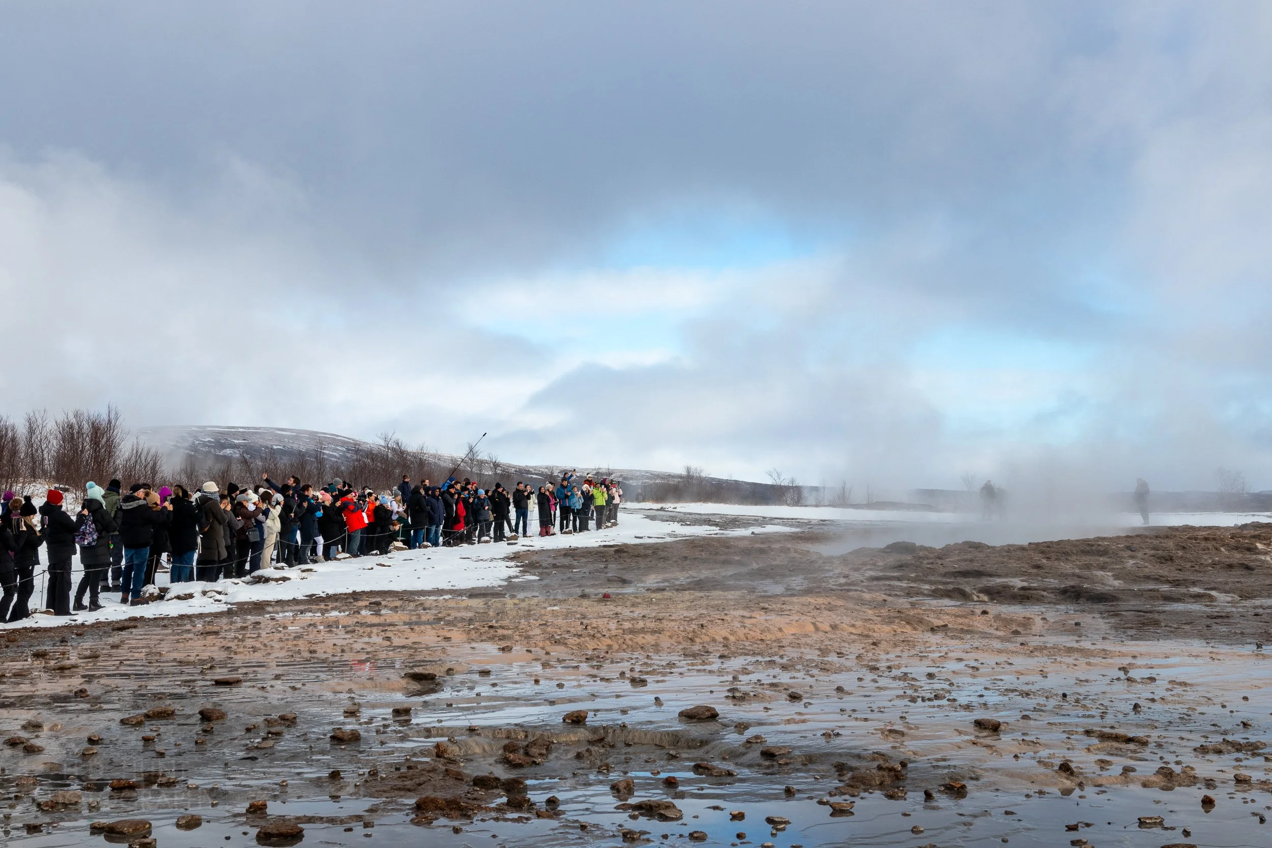 Visitors await the eruption of the geyser Strokkur at Haukadalur, Iceland.