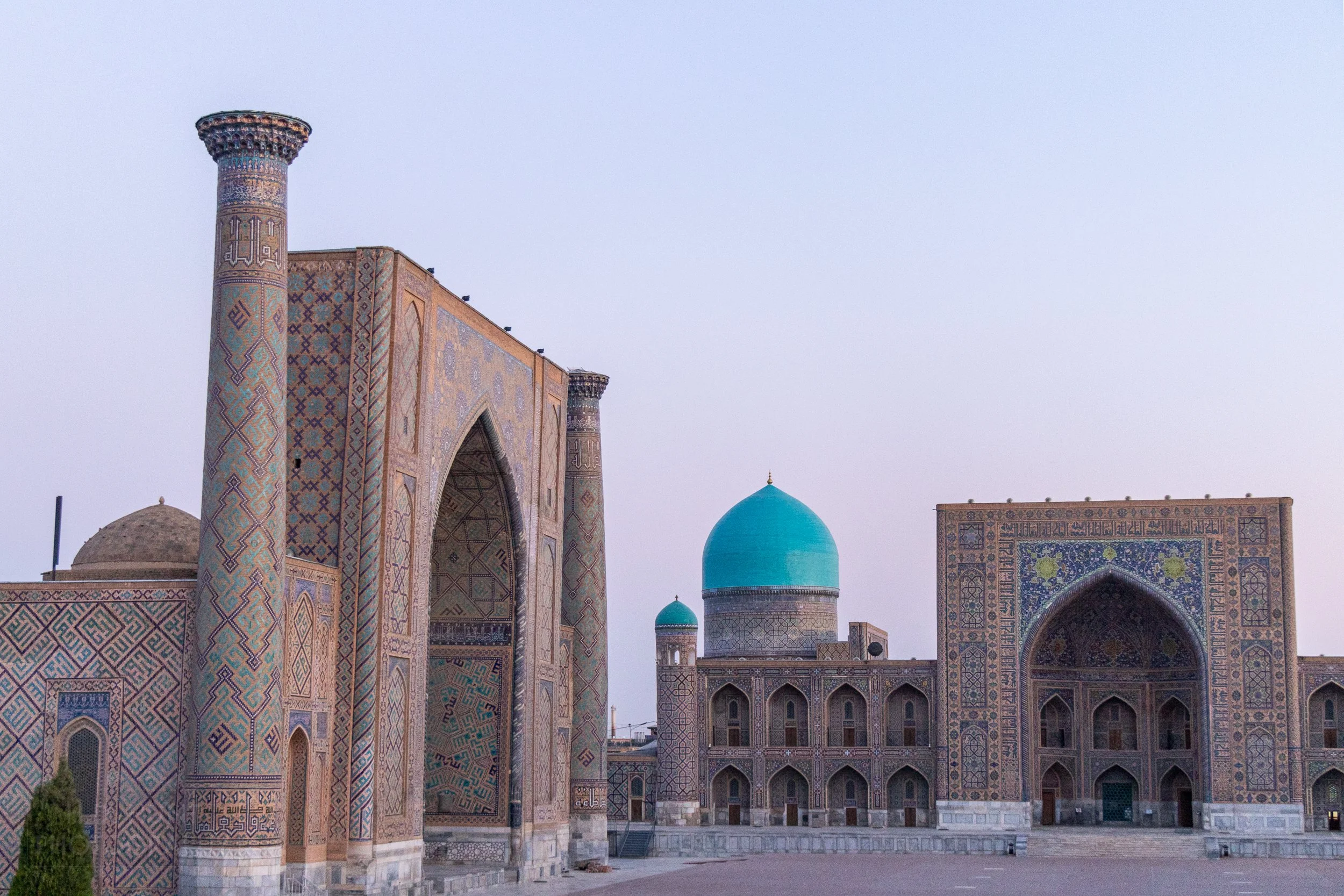 The Registan public square illuminated at sunrise, Samarkand, Uzbekistan.