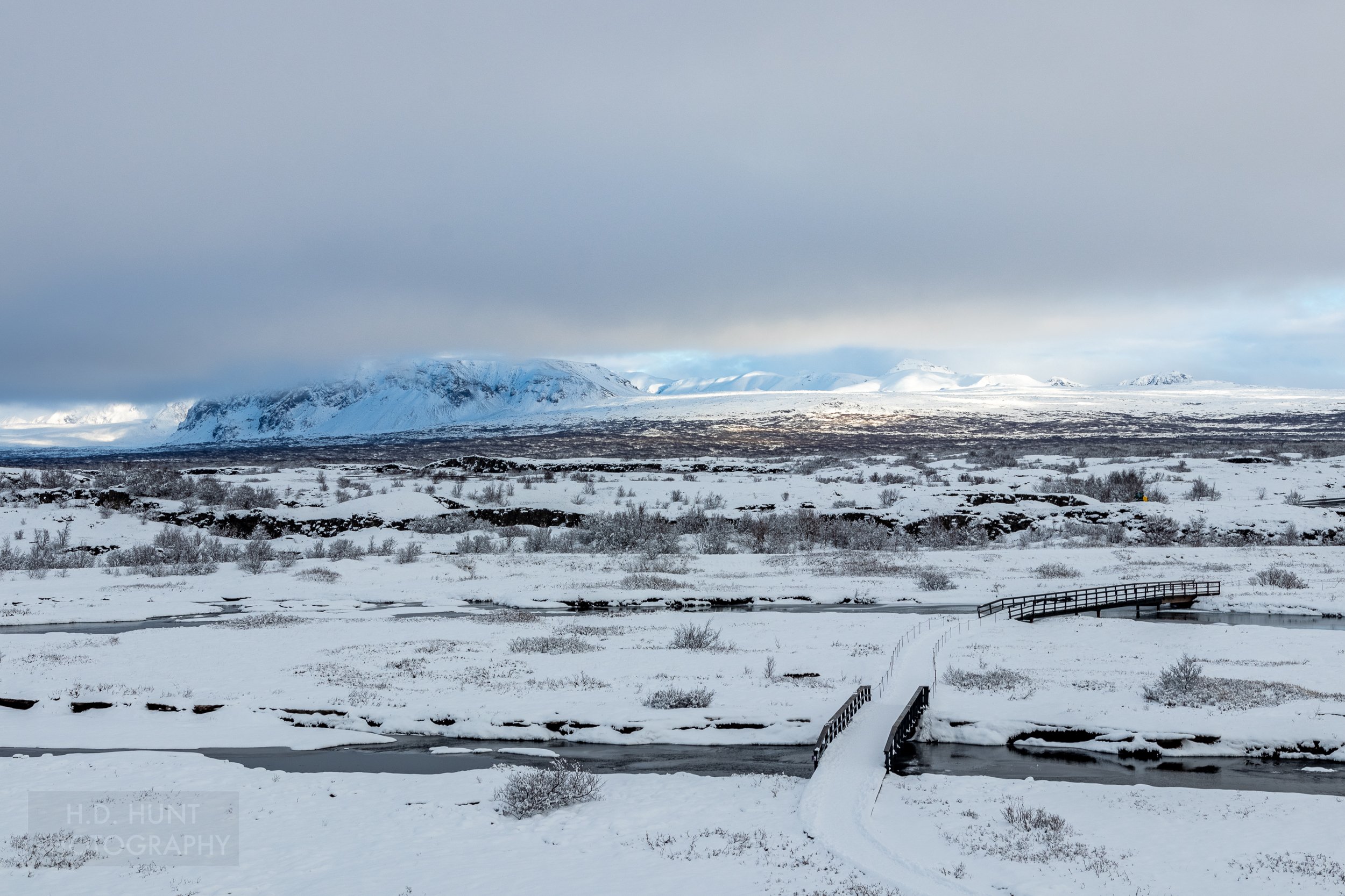 A series of pedestrian bridges cross streams at Þingvellir, Iceland.