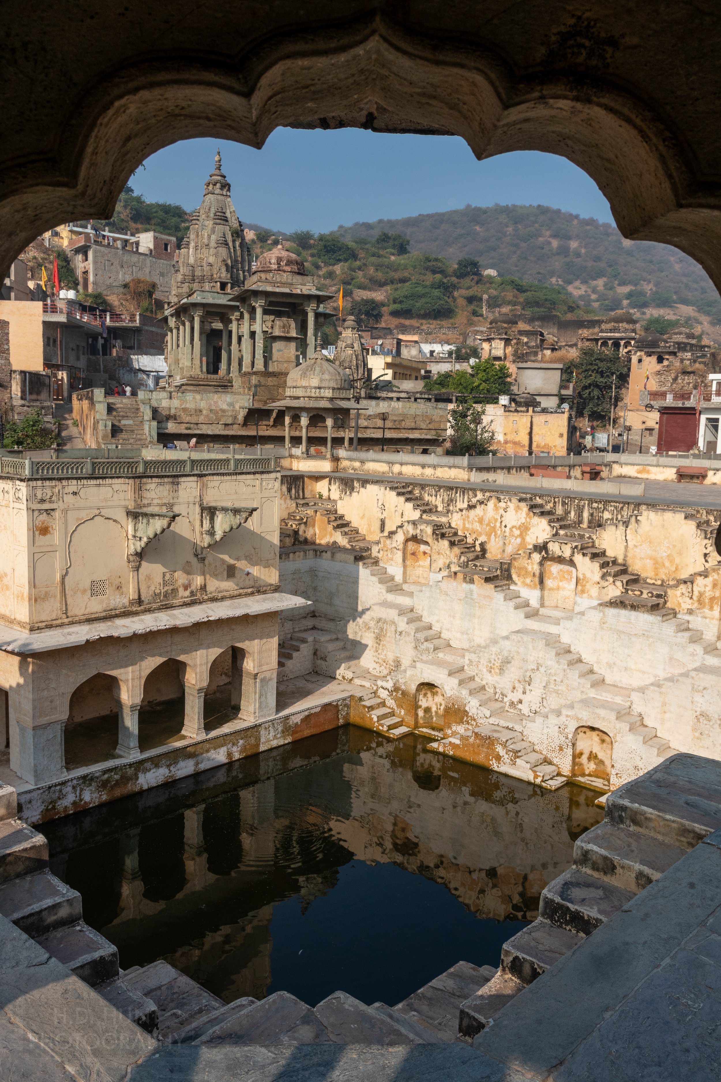 A zig-zag of stone steps rise from a small pool of water at Panna Menna Ka Kund, Amer, India.