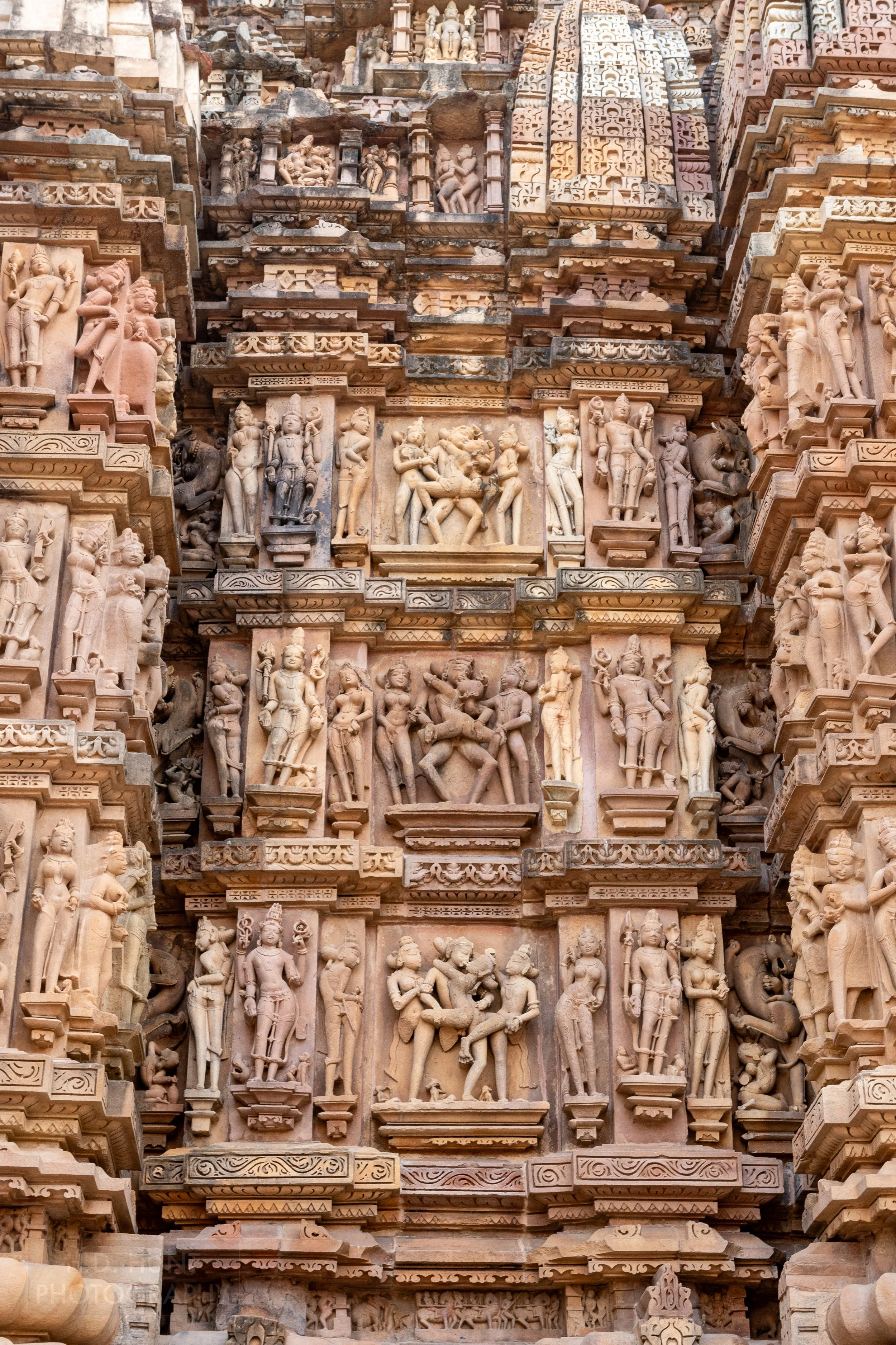 Close-up of the stone carvings adoring Kandariya Mahadeva, Khajuraho Group of Monuments, India.