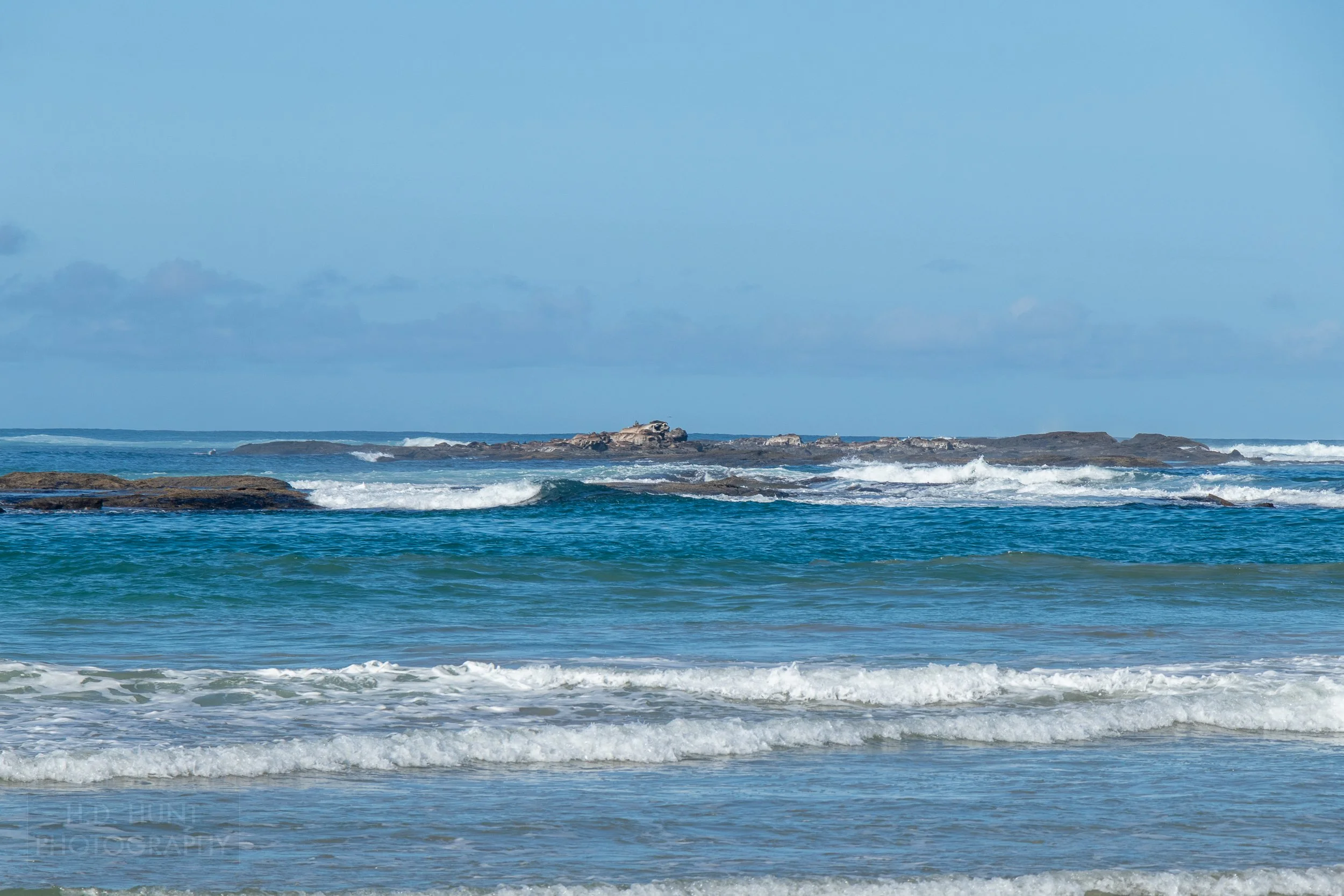 Waves crash into off-shore rocks near Apollo Bay along The Great Ocean Walk, Victoria, Australia.
