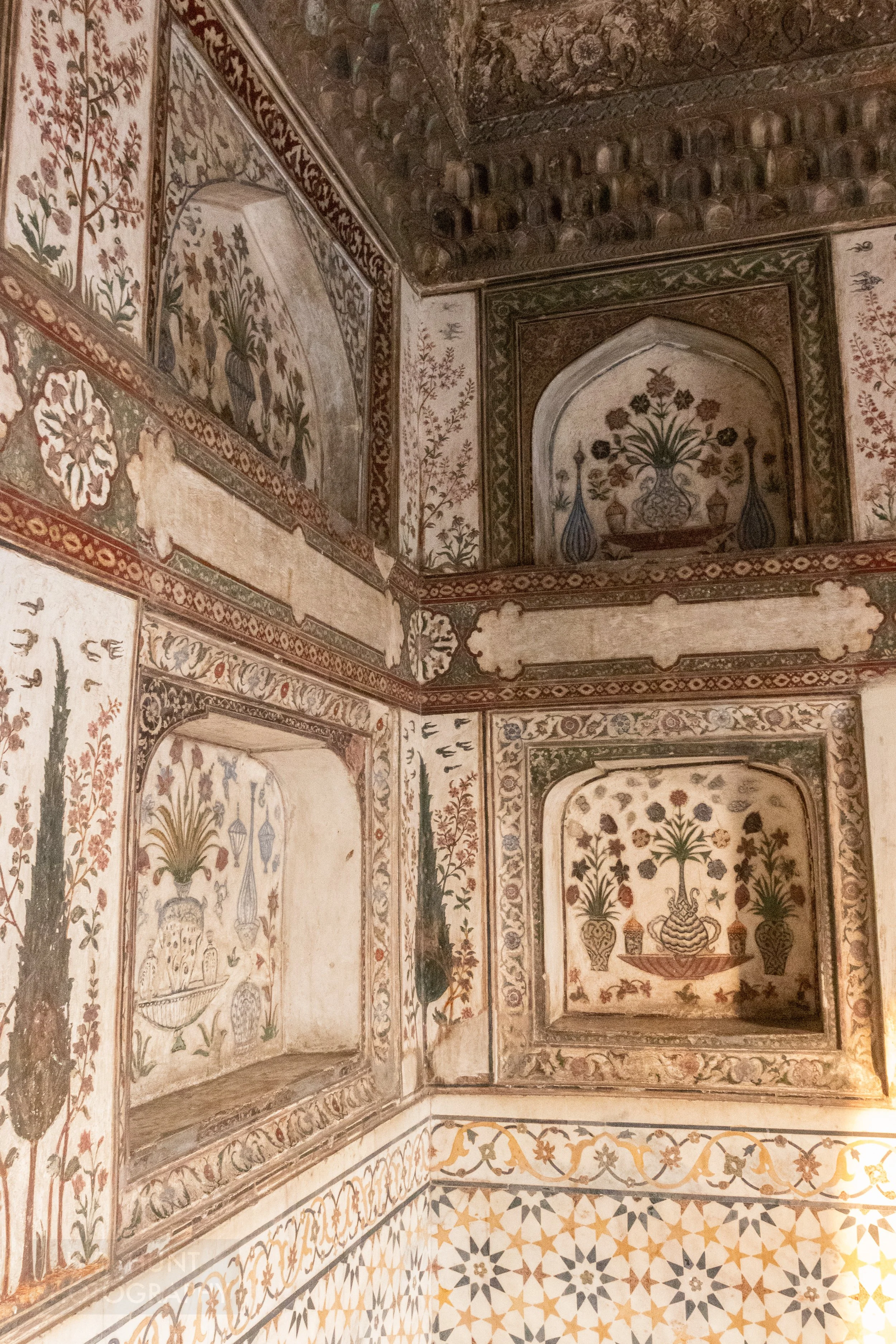 Multi-colored painted images of vases and plants adorn a wall within the Tomb of I’timad-ud-Daulah, Agra, India.