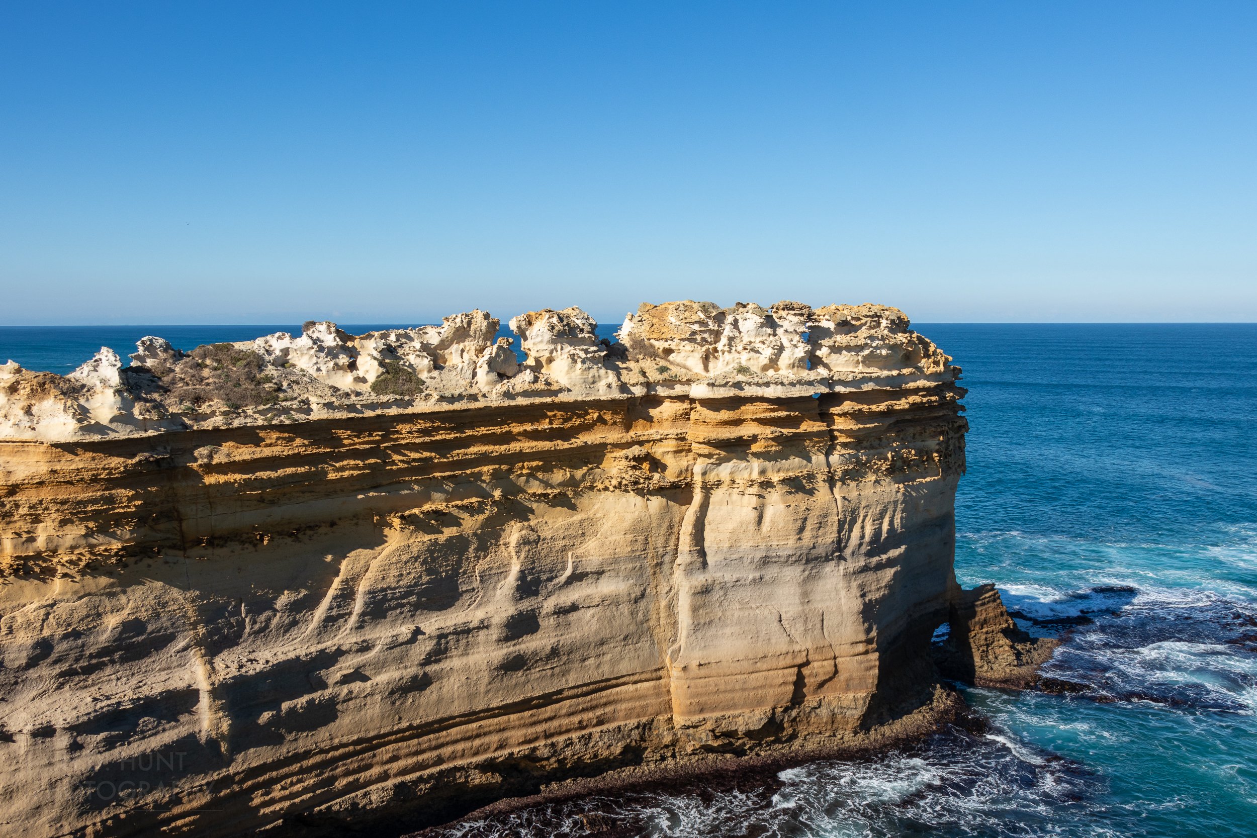 The Razorback limestone formation sits above the blue waters of the Southern Ocean at Loch Ard Gorge, Victoria, Australia.