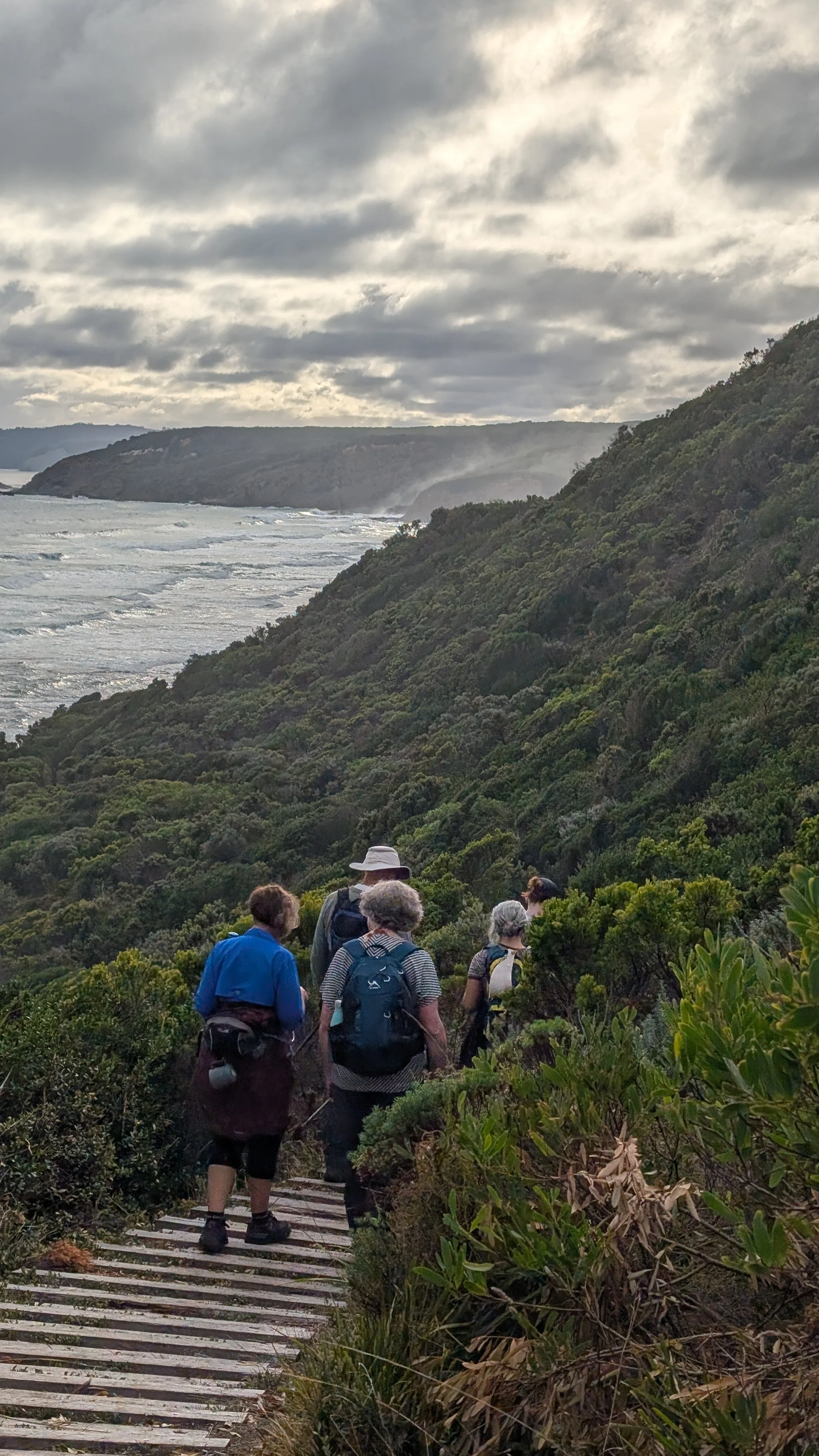 Hikers walk along the Great Ocean Walk in Victoria, Australia.