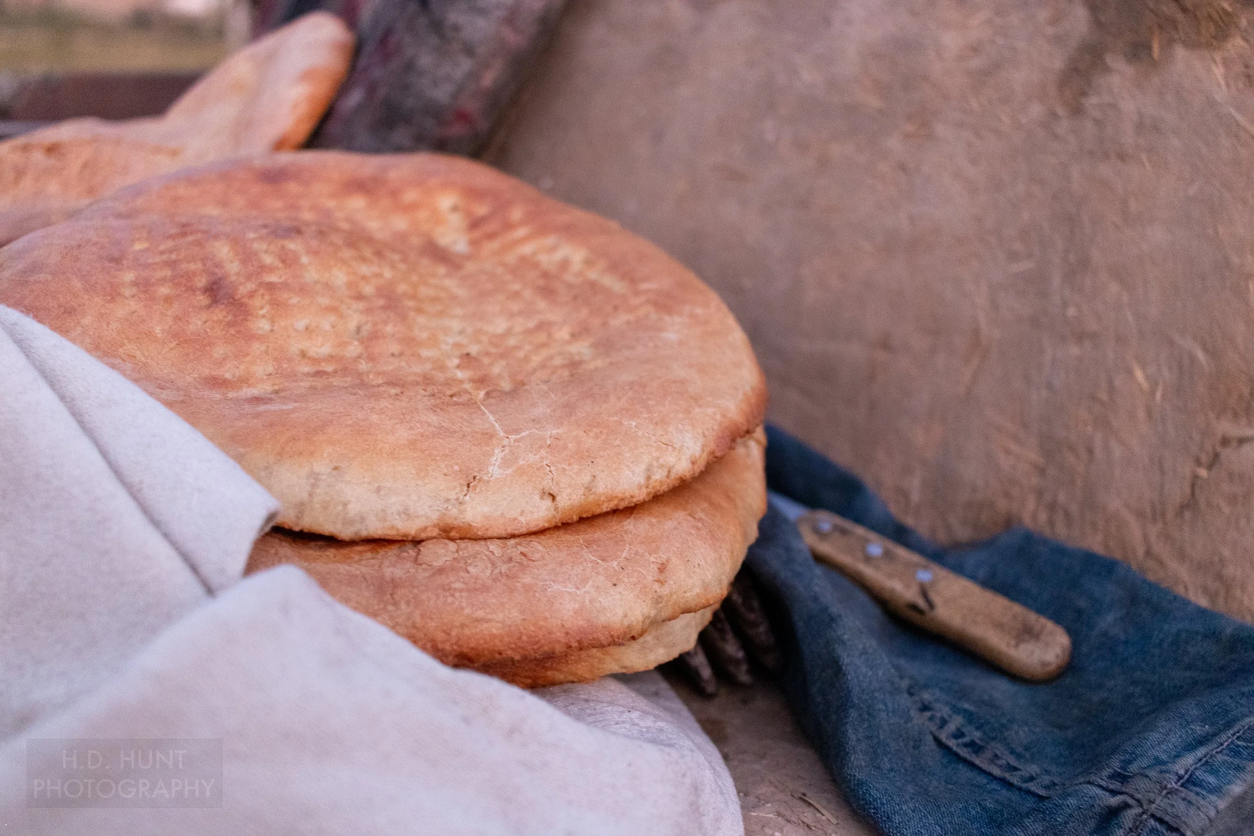Bread sits atop a napkin next to a knife, Yangikazgan, Uzbekistan.